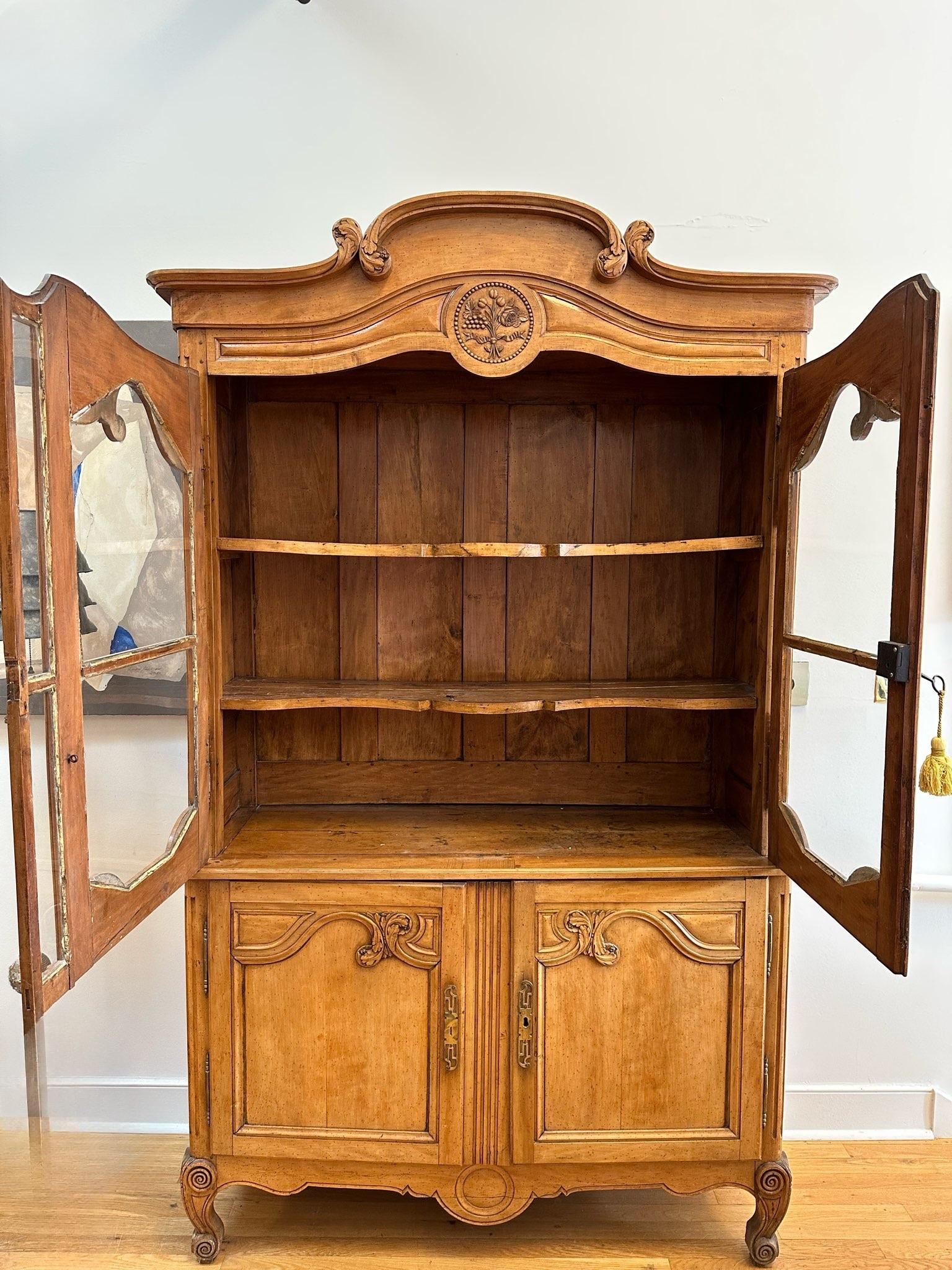 Rare and Wonderful 18th Century French Provincial “Buffet Deux Corps”(Buffet in two parts). Arched Cornice over two glazed cupboard doors  and two original shaped interior shelves. Two further cabinets over a Shaped apron and ”Escargot Feet”. All
