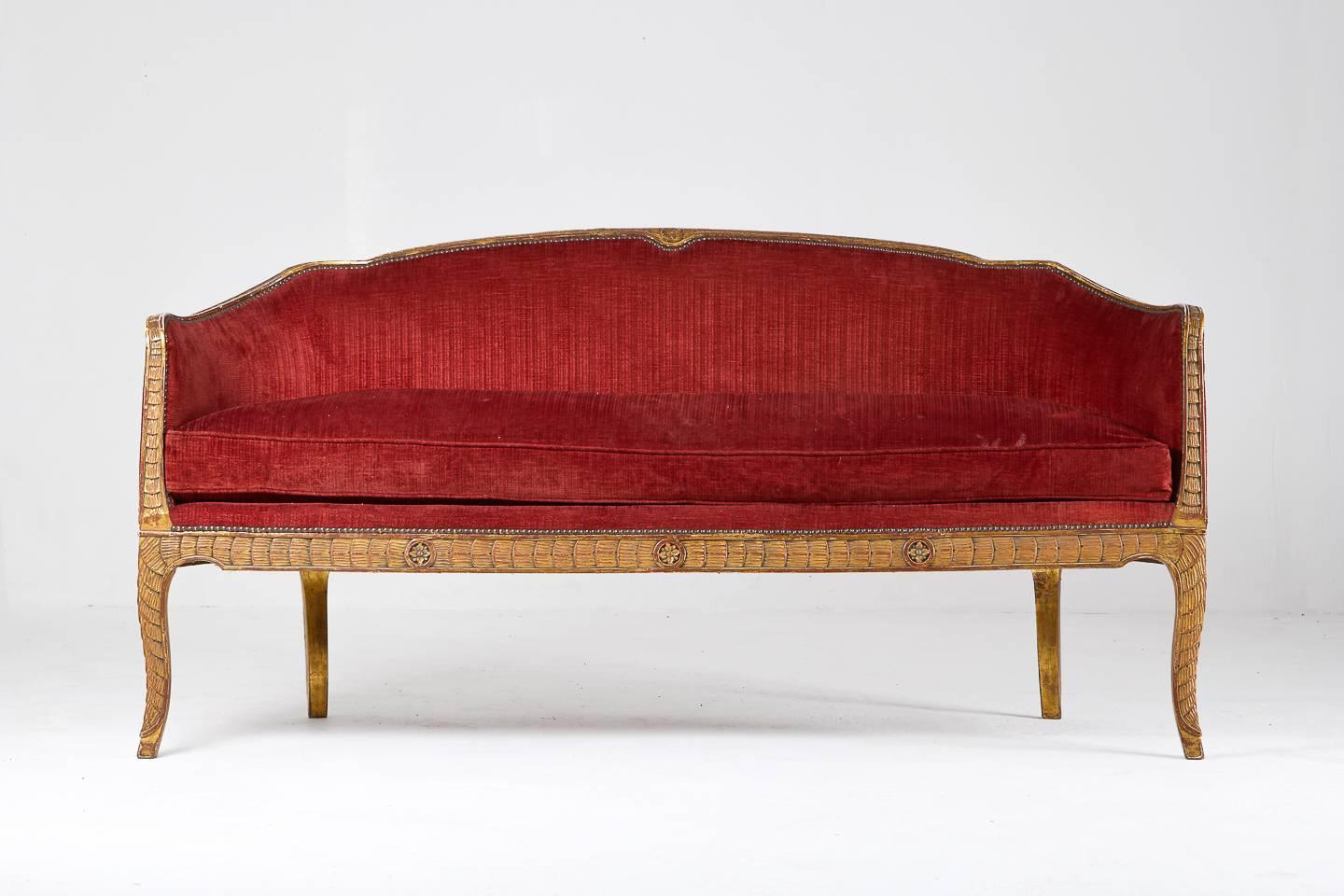 This stunning and rare Italian carved and gilded 18th Century sofa in its original condition has been upholstered with red 1950s fabric. It has fantastic detailed carved wood.

Seat height: 54 cm.
