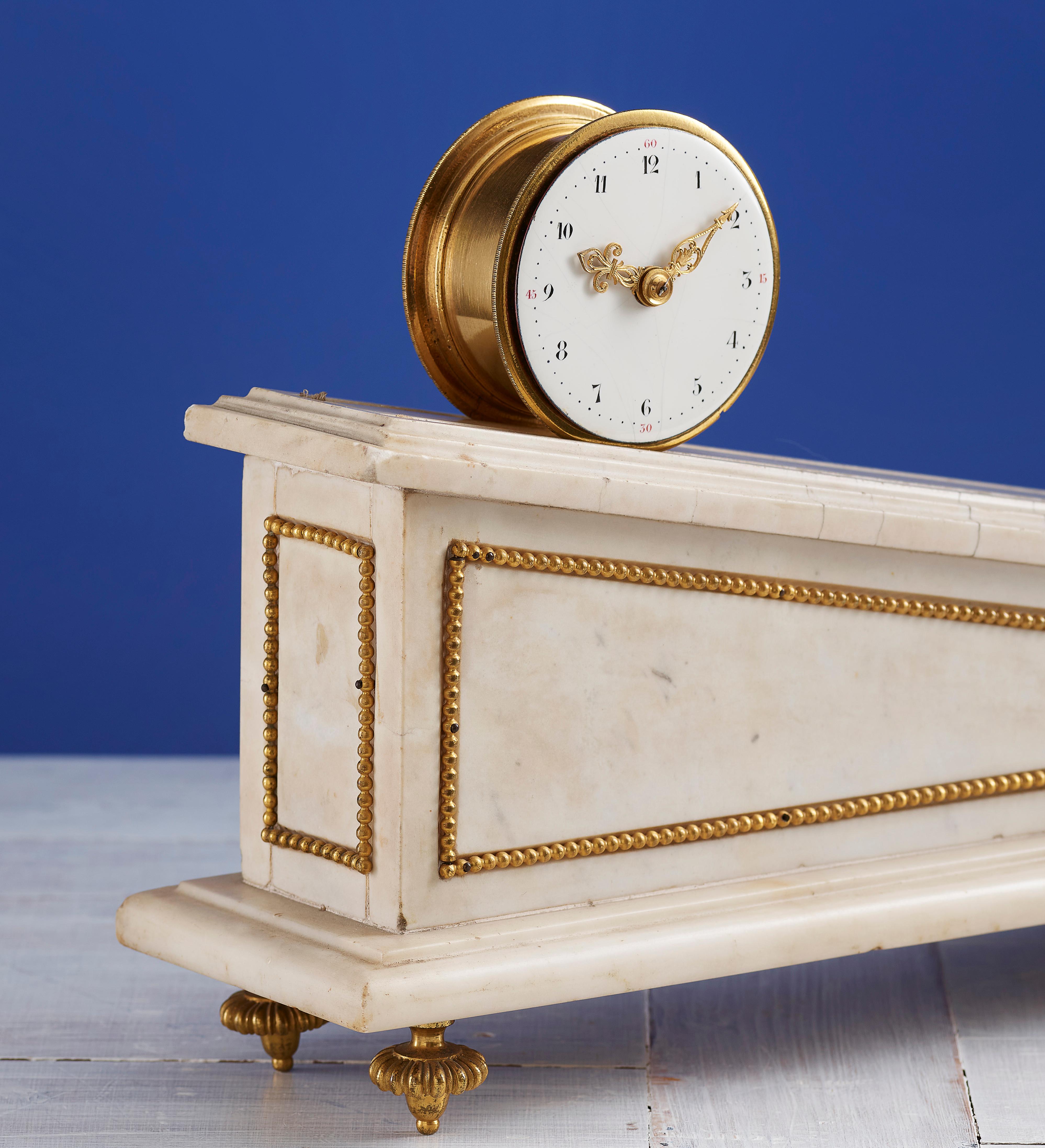 An extremely rare Louis XVI mantel clock 'a cremaillere', a movement driven by its own weight, where the moving drum barrel is running down an inclined white marble base (runs for about three days), mounted with ormolu beading, on toupie feet. The
