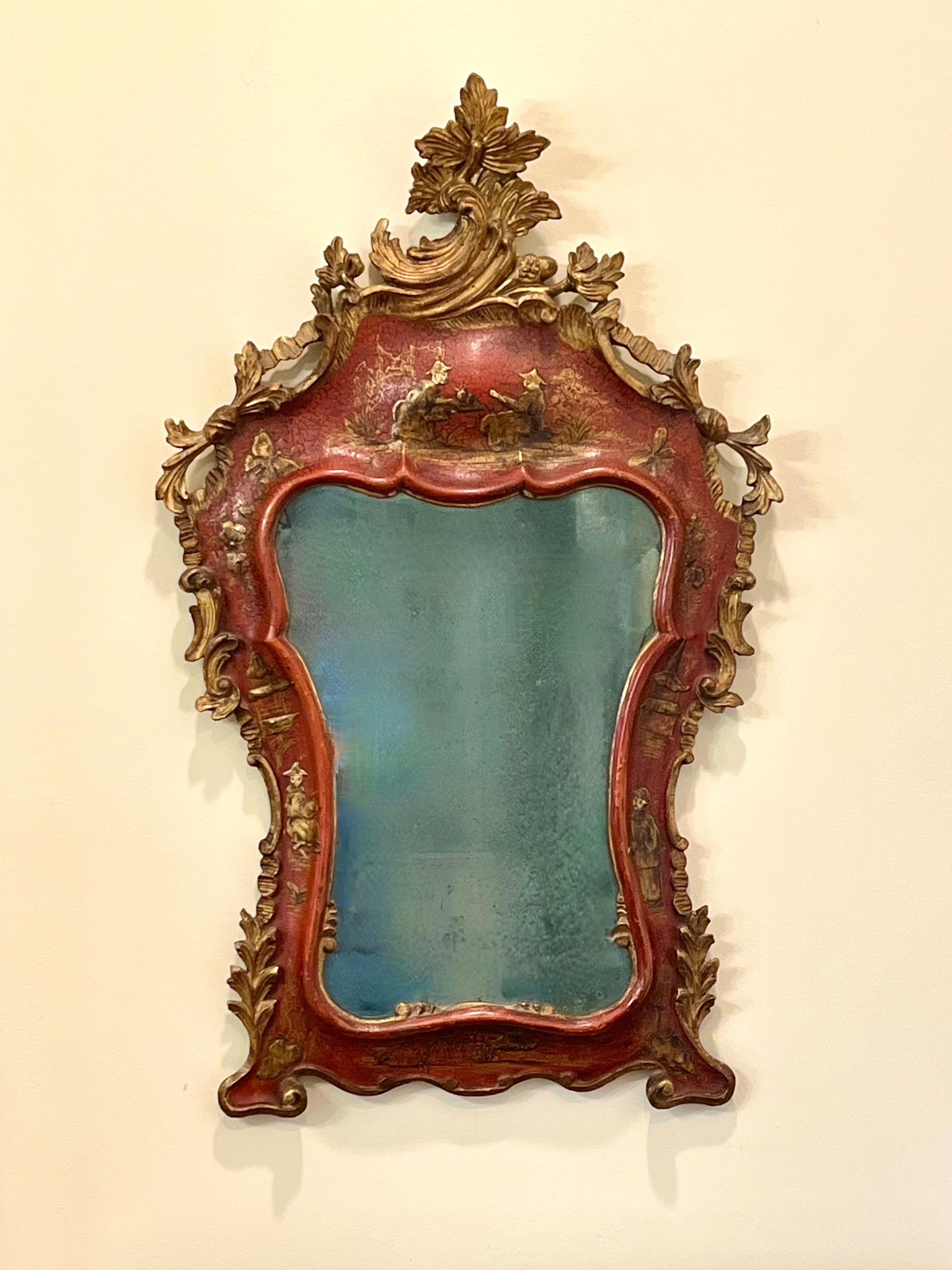A fine and very decorative Queen Anne period red japanned mirror retaining its original original glass plate. This elegant mirror, of dynamic form, is crested with a lovely floral and leaf design and further embellished with typical Asian motifs