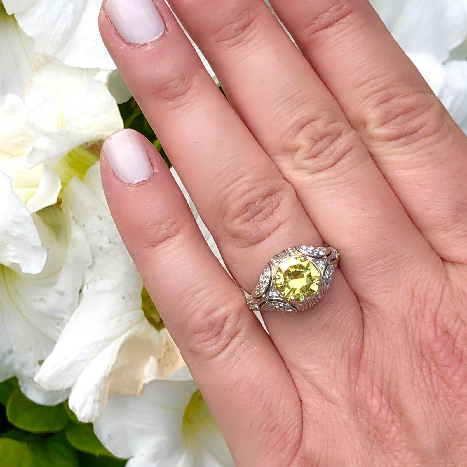A distinctly one-of-a-kind ring. Set with an extraordinary 1.69-cts. octagonal modified brilliant-cut Fancy Intense Yellow diamond, SI1 clarity, on a handcrafted French-made openwork mounting be celebrated designer Sebastien Barier, which is set