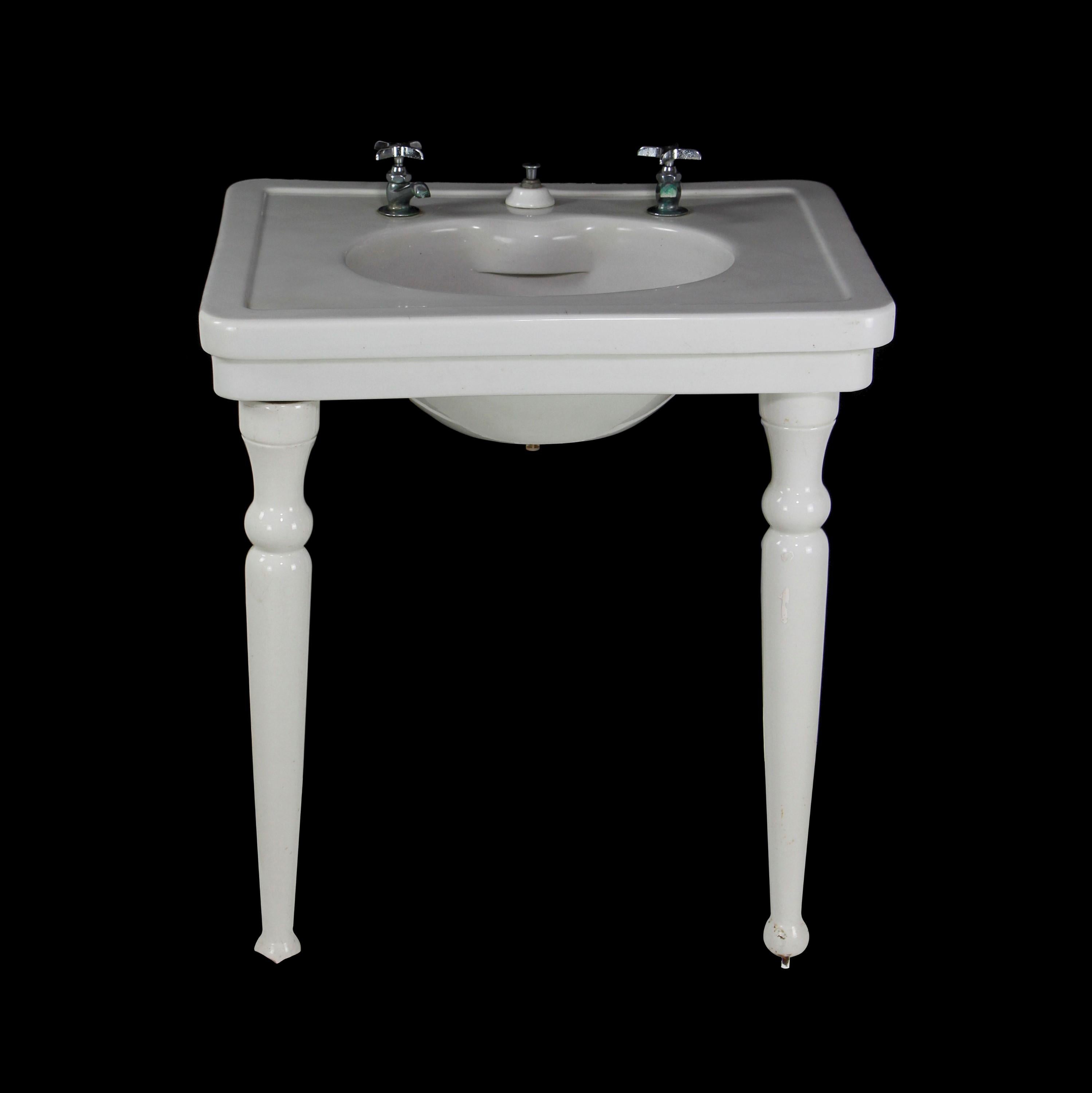 Please note the bottom of the left leg needs repairs. Please see the photos.

1904 white antique vitreous porcelain sink with two matching legs in front and wall mounted in back. This comes with the original hardware. Patented April 5, 1904. Made