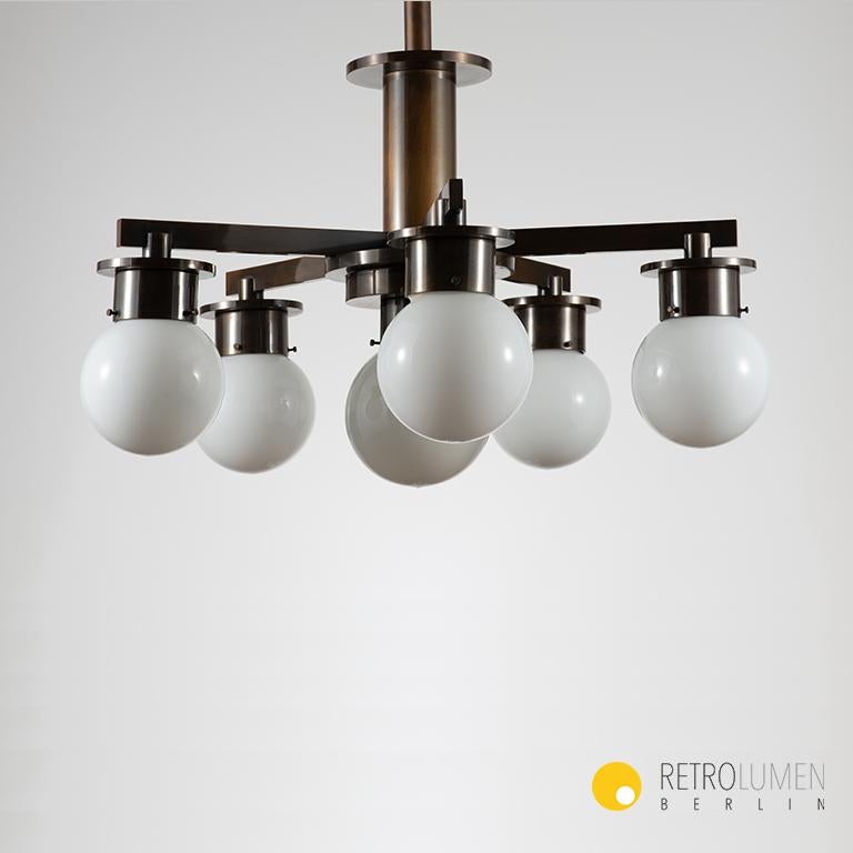 Step back in time and illuminate your space with the elegance of the 1930s through this rare and authentic Modernist chandelier, a masterpiece in Bauhaus design. This chandelier is not just a lighting fixture; it's a piece of history, a testament to