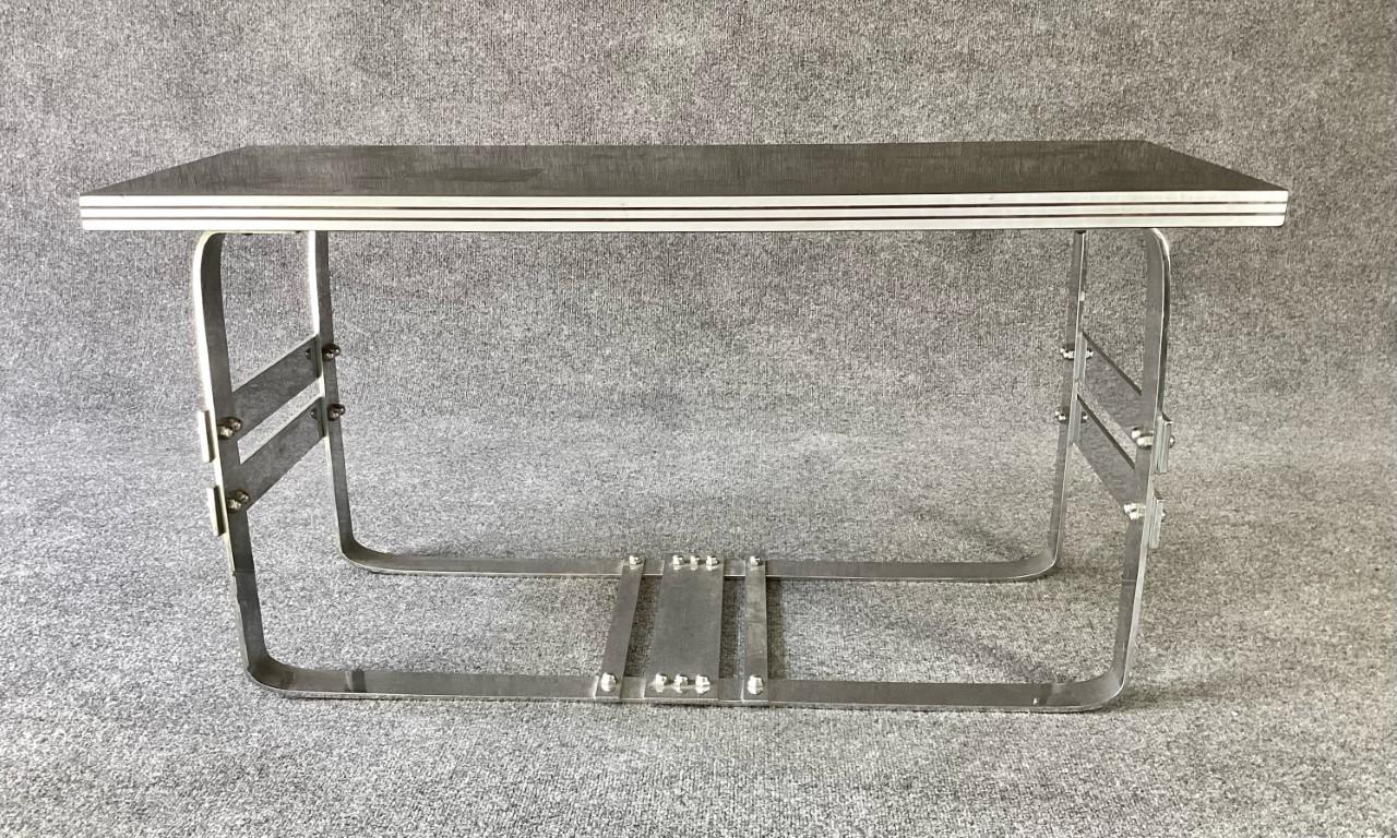 Rare Art Deco or Art Moderne black and chrome coffee table. Very possibly shown in the 1939 Worlds Fair. Attributed to Wolfgang Hoffmann for Howell, truly amazing design. Chromed steel heavy architectural base. Laminate or bakelite top with ribbed