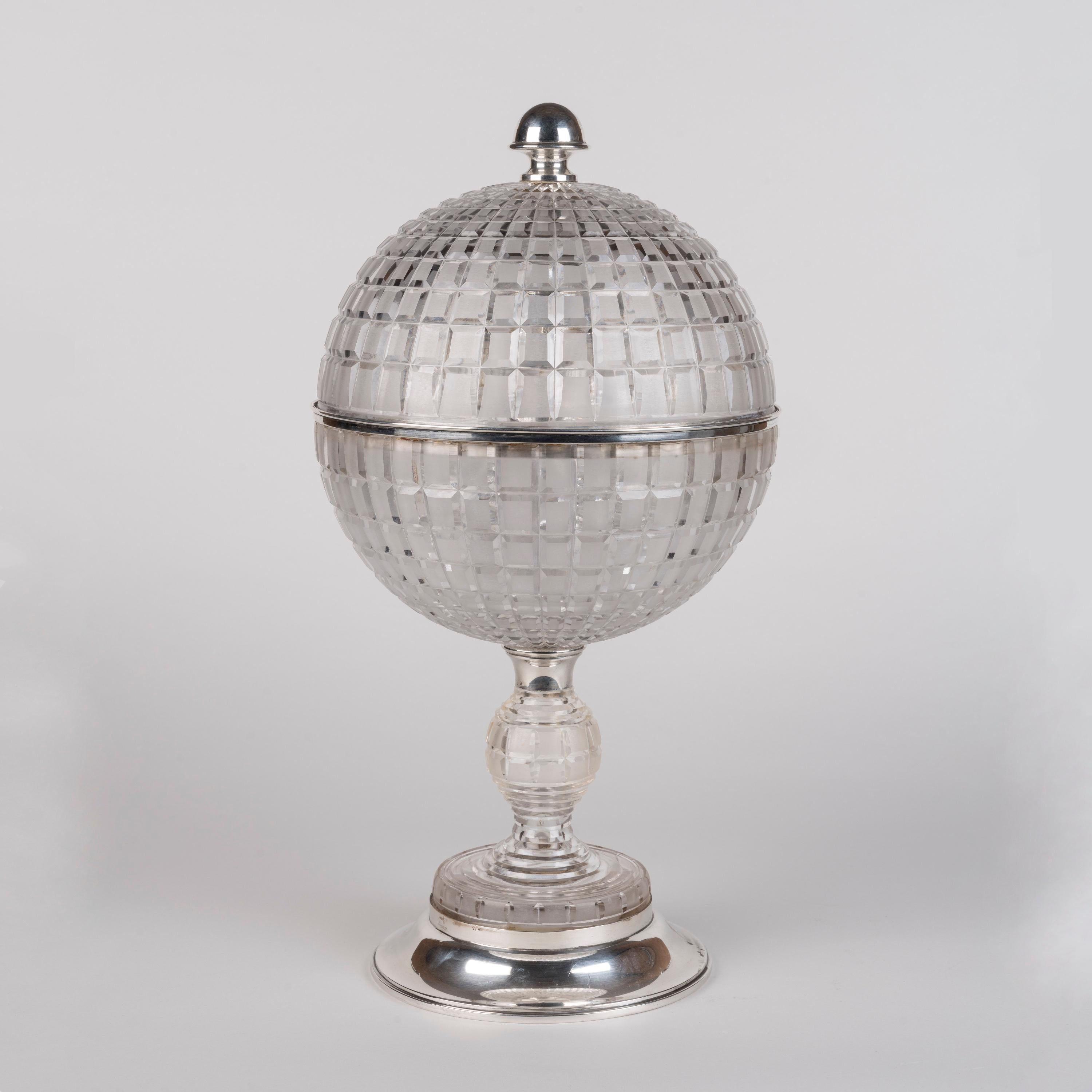 A Rare Art Deco Crystal Cave à Liqueur

With hallmarked solid silver fittings, the crystal globe supported on a circular foot and stem, the lid opening to reveal the interior designed to house the carafe and six glasses. Bearing Barcelona hallmarks