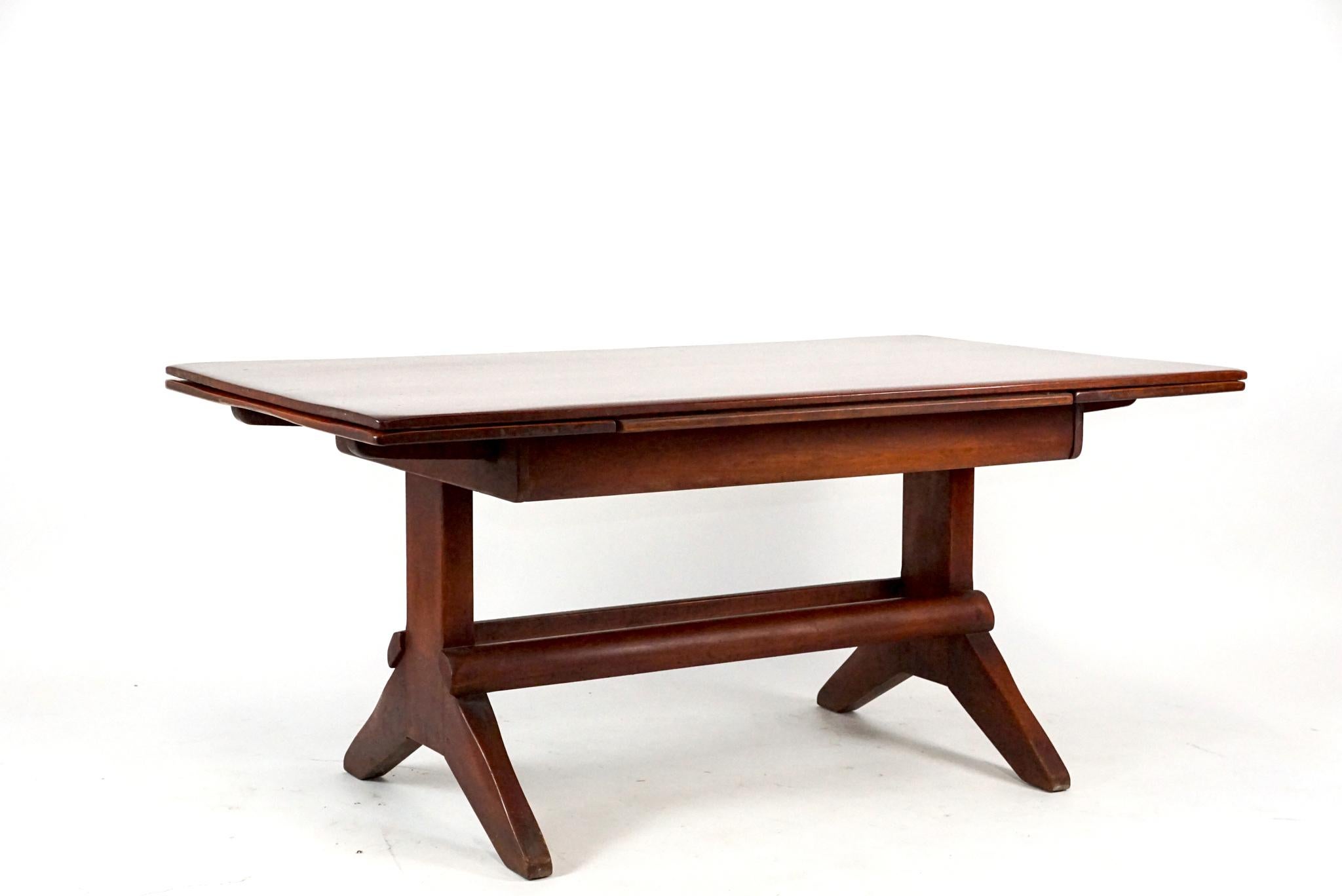 A very rare 1930s Cushman Trestle /extension dining table in warm russet original finish. Table when fully extended comfortably seats eight. Designed by Herman De Vries and only offered for one year. The table will mix well with Modern or Adirondack