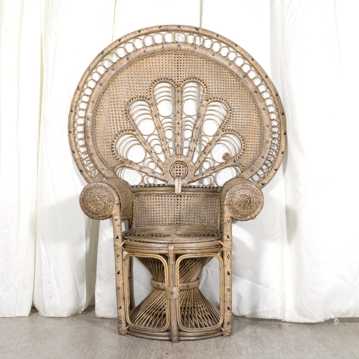 A large, classic 1930s Peacock chair handcrafted in France of woven two-toned rattan and wicker. Having a flamboyant shaped high flaring back that resembles the fanned feathers of the bird after which it's named, this rare chair features large