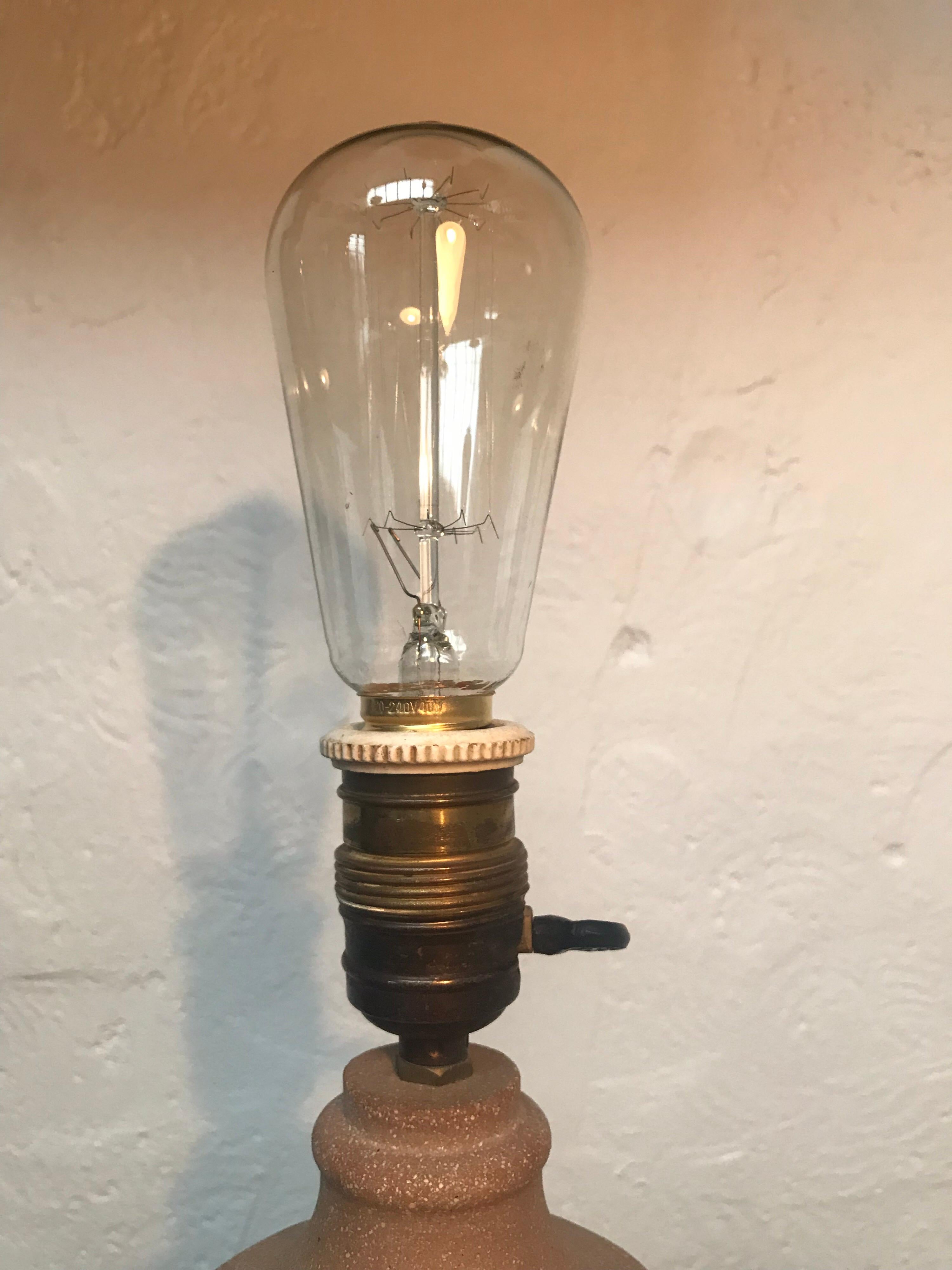 Rare 1930s Just Andersen table lamp in sandstone.
Brass and ceramic bulb holder.
Rewired.
Just Andersen logo on base with model number 66.
In very good condition with no chips or cracks.
Just Andersen was a Danish designer born July 13, 1884,