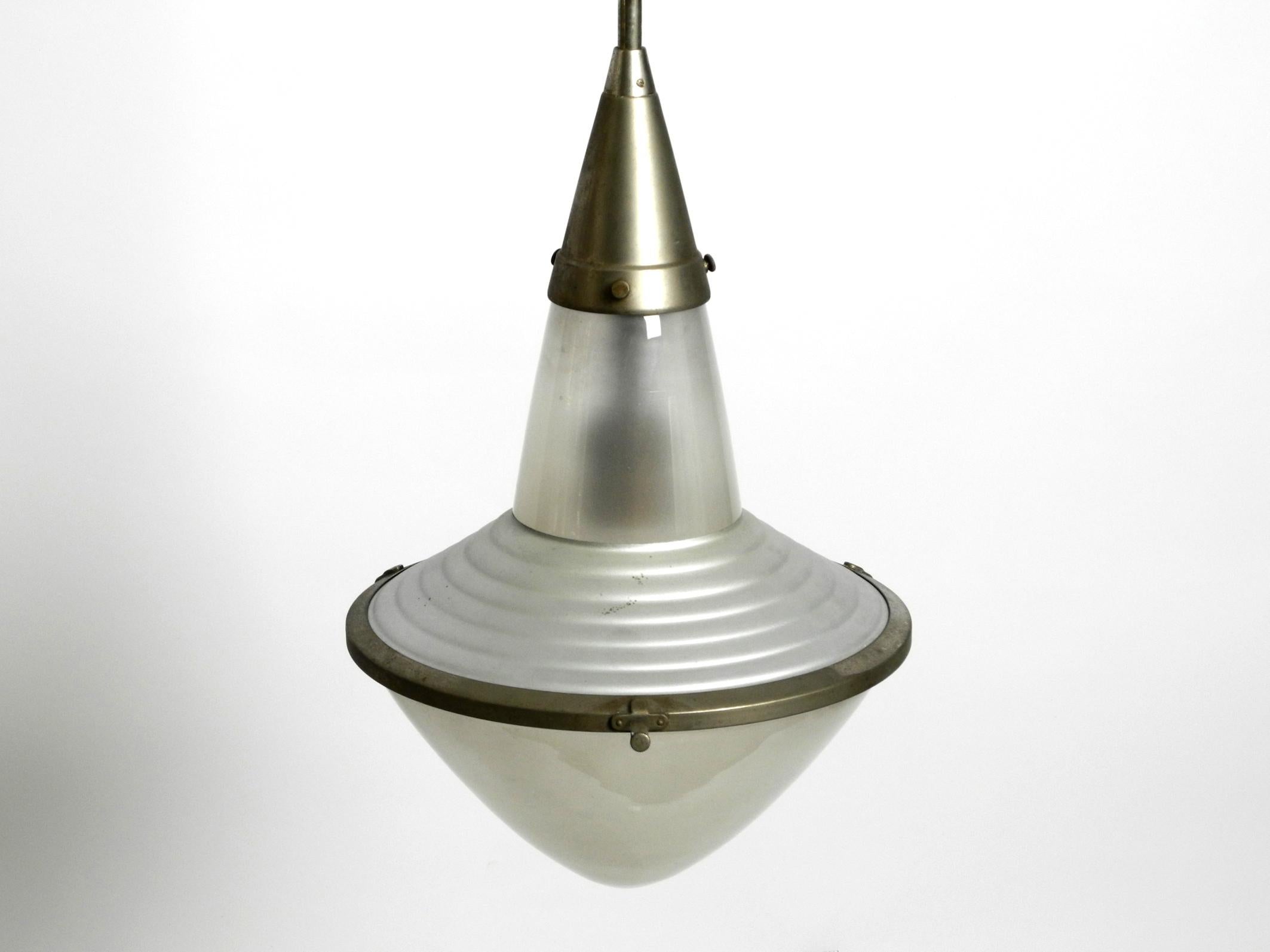 Very rare 1930s pendant lamp by Adolf Meyer for Zeiss Ikon with an adjustable shade.
Great extraordinary industrial design from the 1930s.
Made in Germany. With original label on the upper shade.
Frame and canopy made of nickel-plated metal.
The