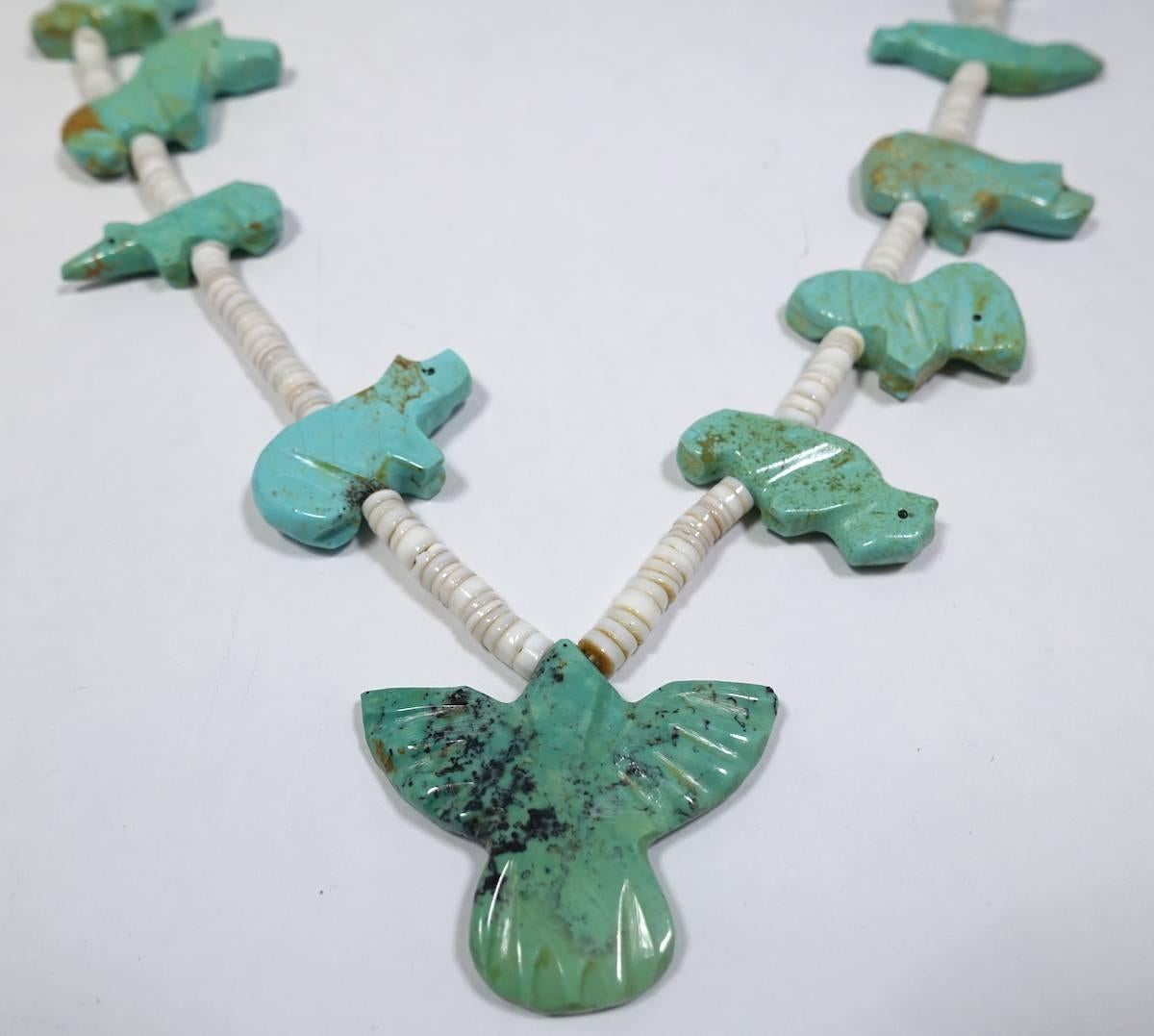 This rare, vintage fetish necklace features huge turquoise fetish.  It has a silver latch that was added on years later.  This piece measures 22-1/2” long with a toggle closure. The rare part of this necklace is the large size of each turquoise