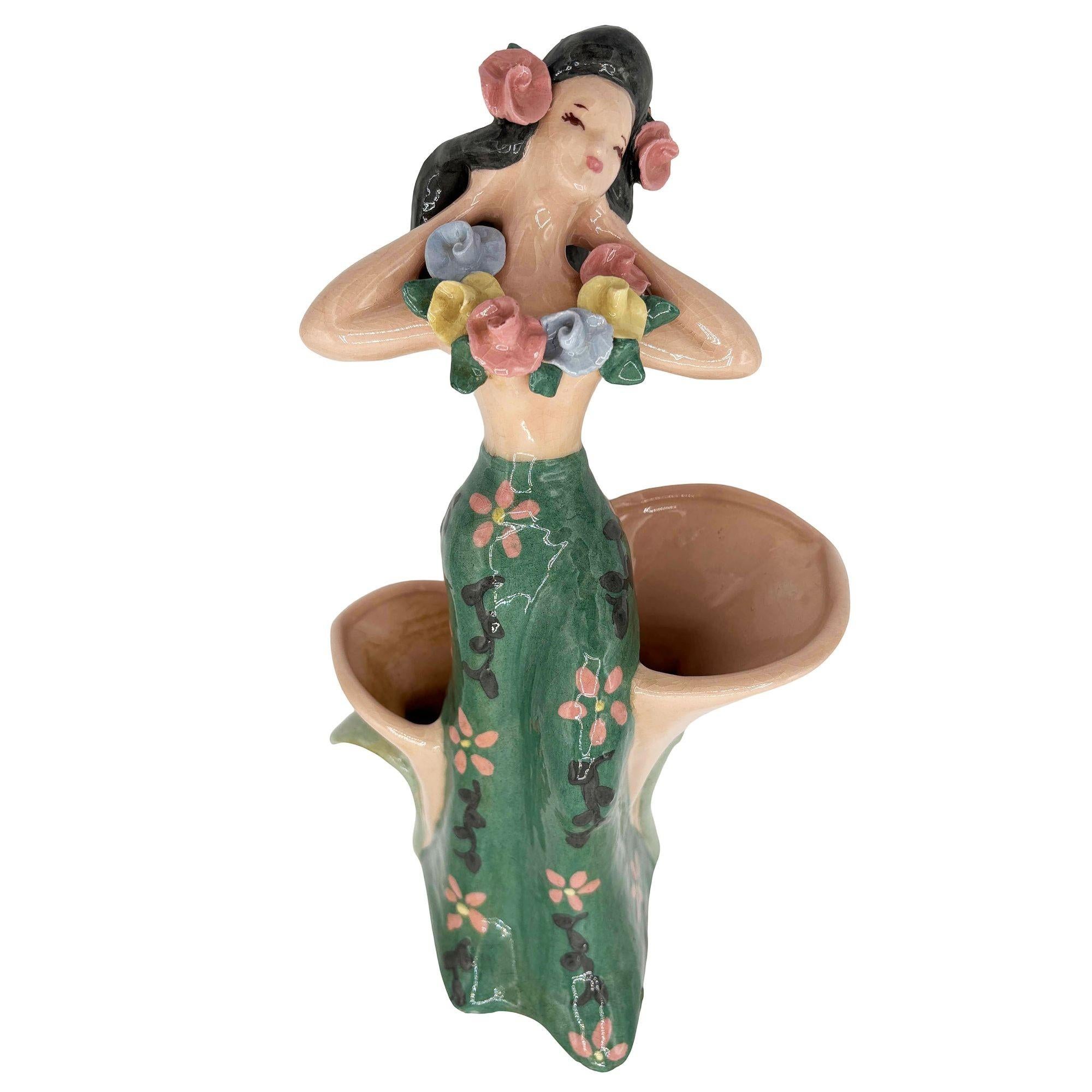 Original early Mid-century Dancing Hula Girl Vase by Kaye of Hollywood/Dorette Saltzman. The vase features a beautifully detailed Hula Girl resting against two cone-shaped tropical flowers. It comes in a gloss finish that highlights the rich colors