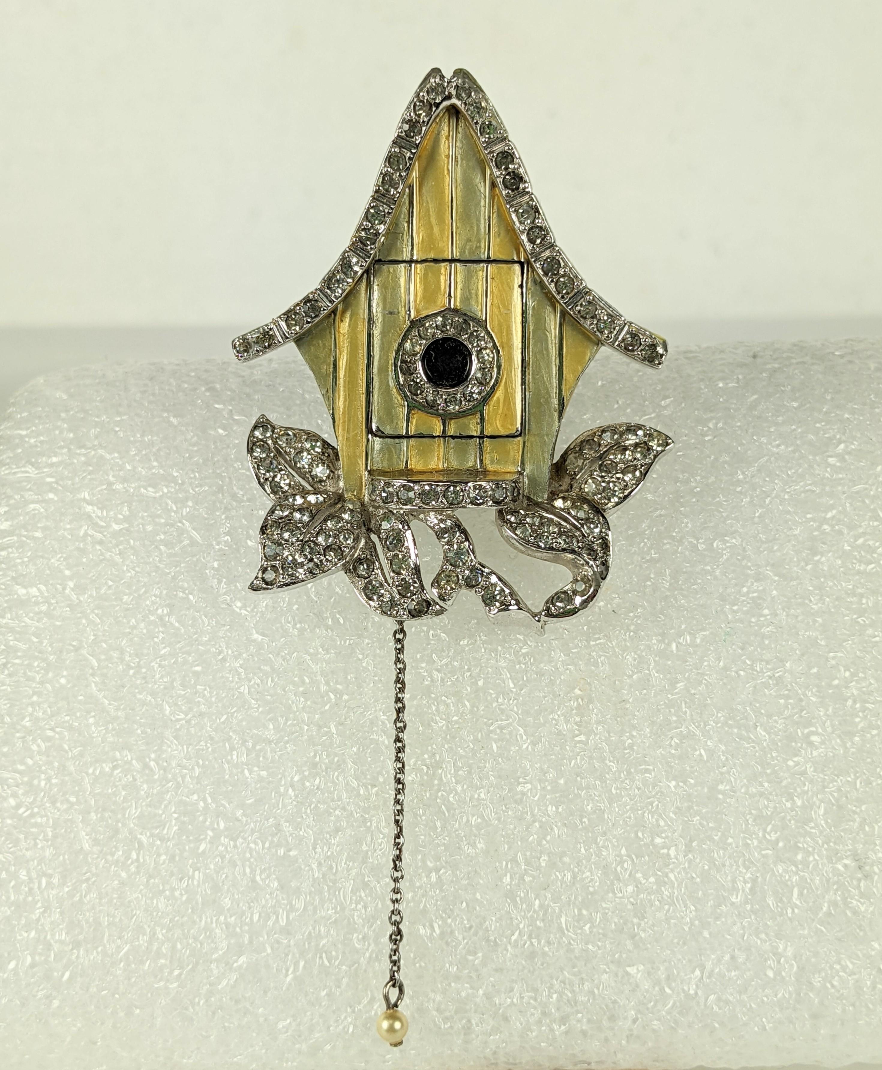 Rare Marcel Boucher pave rhinestone and enamel mechanical trembler cuckoo clock clip brooch.
In a pale mint green and  lemon yellow pearlized enamel, crystal rhinestone pave, rhodium plated base metal, with faux pearl  drop on the silvered metal