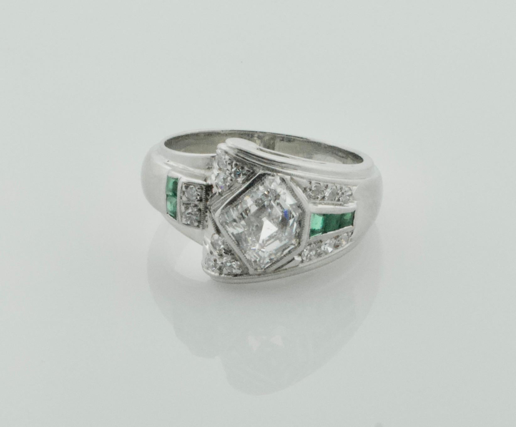 Rare 1940's Diamond and Emerald Ring in Palladium 1.83 E - VS1 Shield Cut
One Shield Cut Diamond weighing 1.83 carats [E - VS1]  GIA certed
Fourteen Single Cut Cut Diamonds weighing .20 carats approximately [GH VVS - VS1]
Five Calibrated