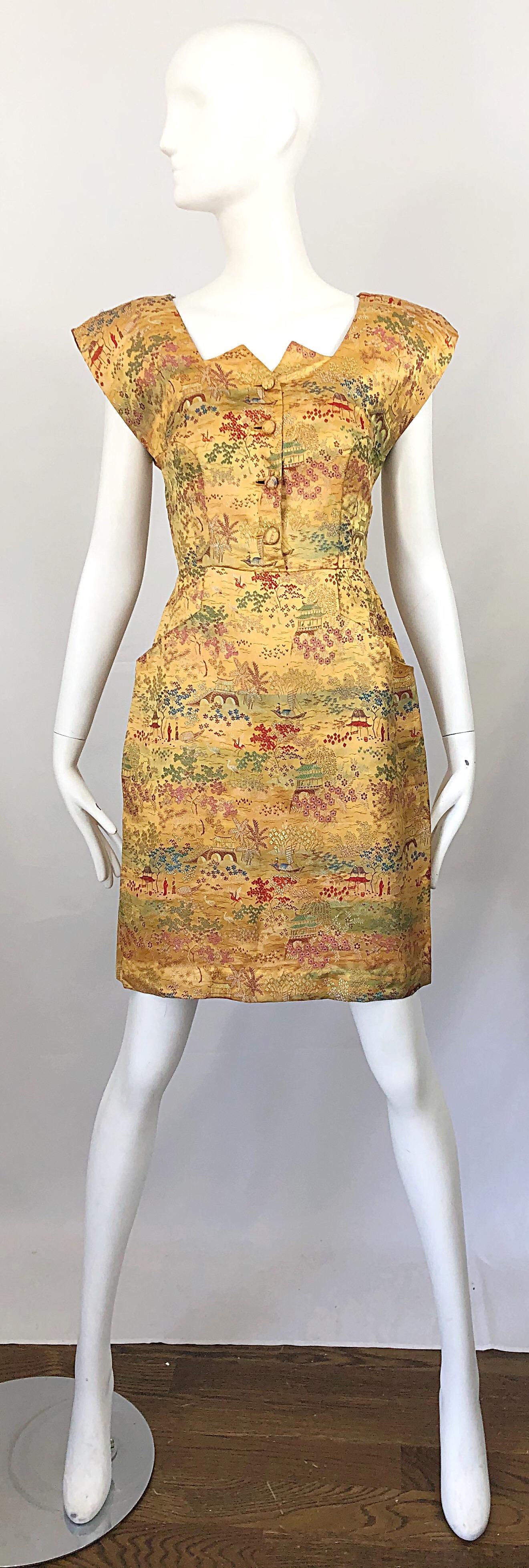 Rare vintage mid 40s novelty Asian print strong shoulder silk dress! Features a warm marigold yellow color. Prints in red, green, blue, orange and ivory throughout. Metal zipper at the side chest. Buttons up the front in silk fabric covered buttons.
