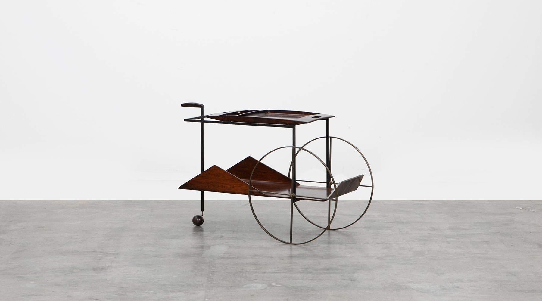 This Brazilian modern Classic piece was designed in 1959 by Jorge Zalszupin. The exquisite barcart is made in Brazilian jacaranda with brass wheels. The top shelf is a removable tray. Noble lines, the essential use of native wood and a combination