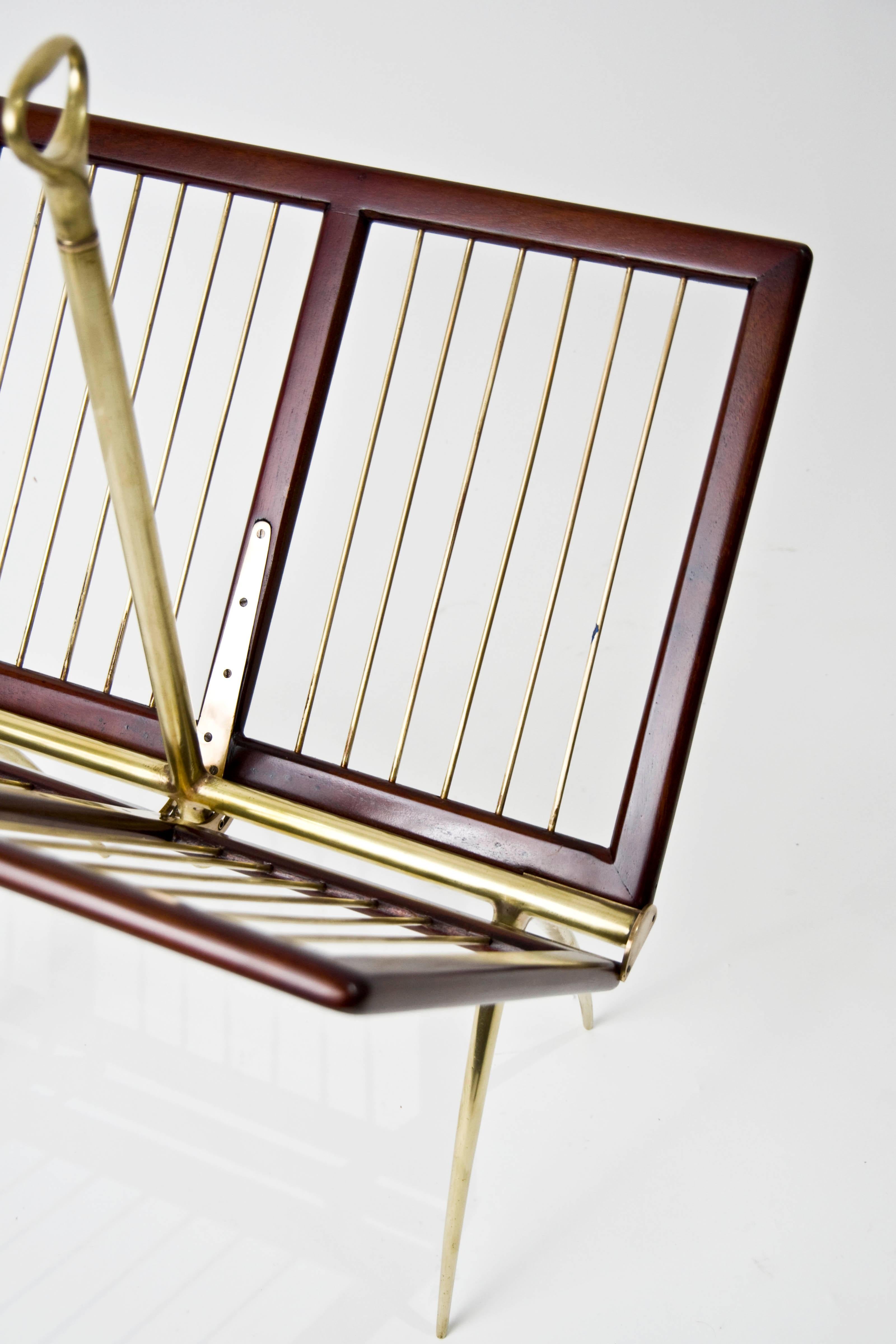 Born Naples in 1972 Italian architect designer Cesare Lacca created modernist furniture and metalwork throughout the 1950s This unusual magazine rack is constructed of mahogany and brass with an open and close mechanism.

Dimensions 26.75” H x