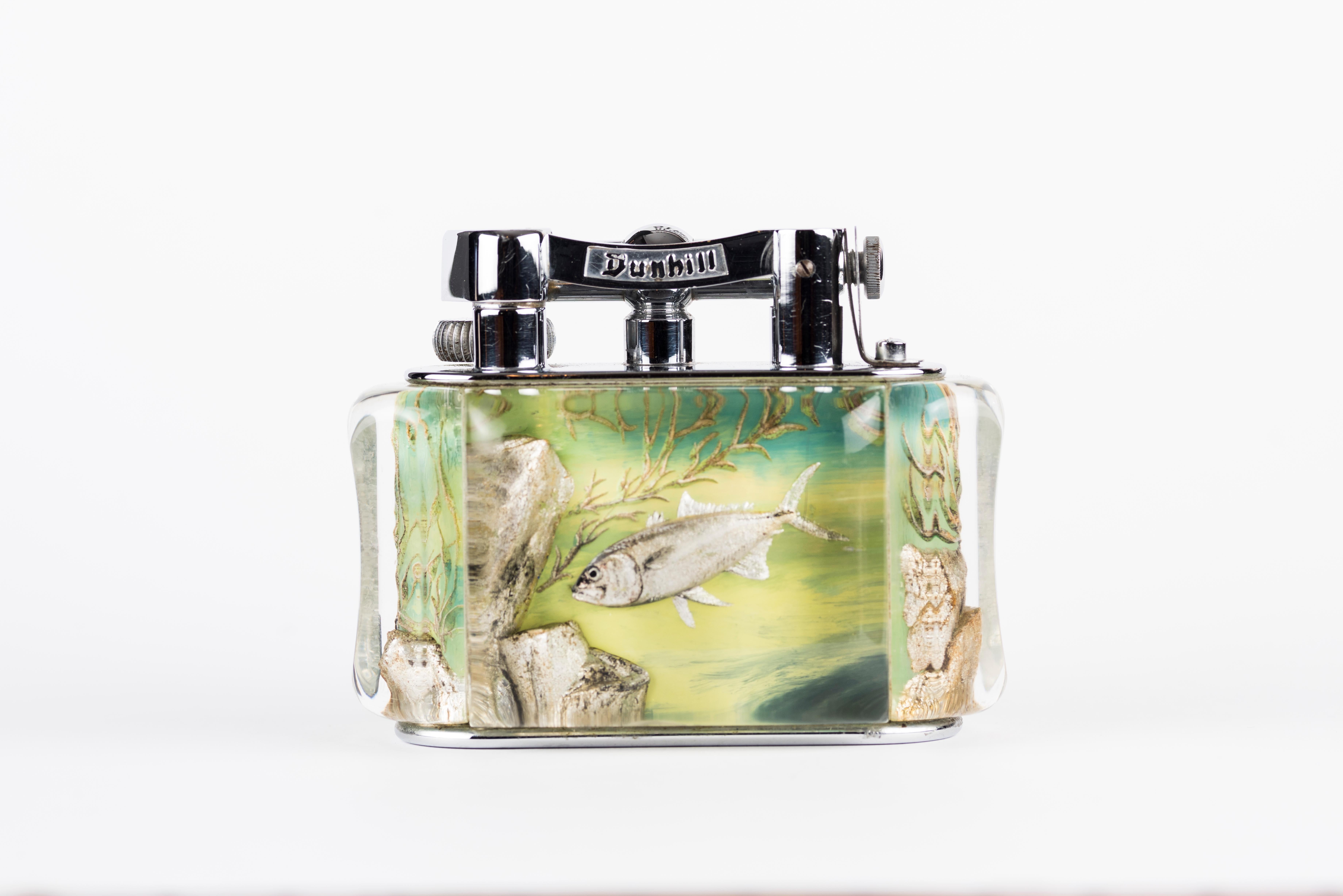 A rare 1950s Half-Giant Dunhill aquarium table lighter (made in England) with chrome plated metal work
Each of these lighters are very rare and unique as they were hand carved and painted and no one look exactly similar.

Ben Shillingford