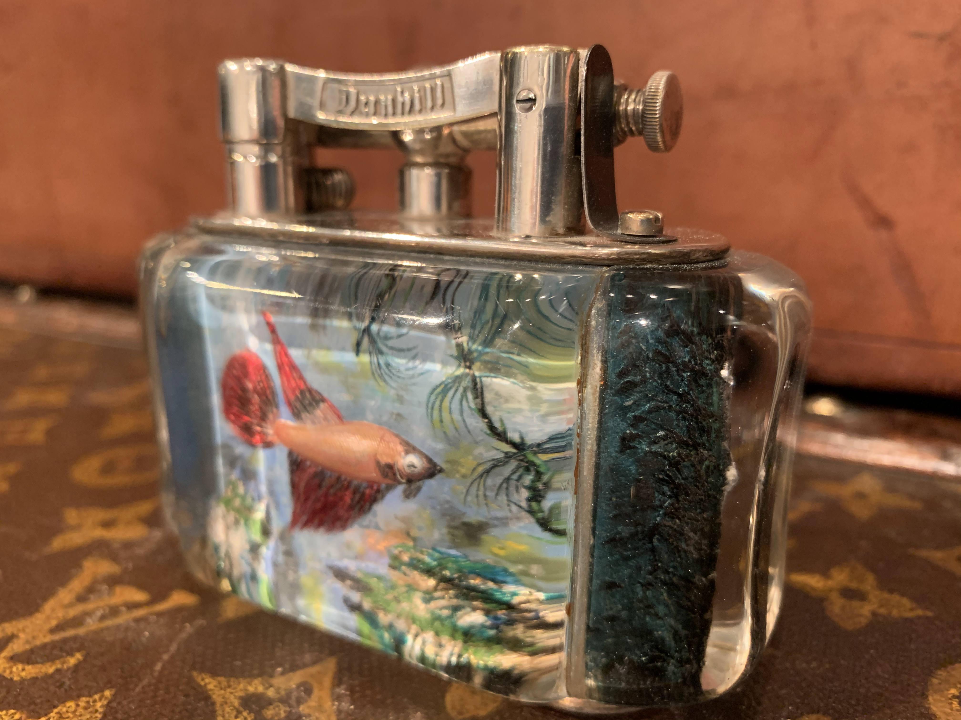 A rare 1950s Half-Giant Dunhill aquarium table lighter (made in England) with silver plated metal work
Each of these lighters are very rare and unique as they were hand carved and painted and no one look exactly similar.

Ben Shillingford