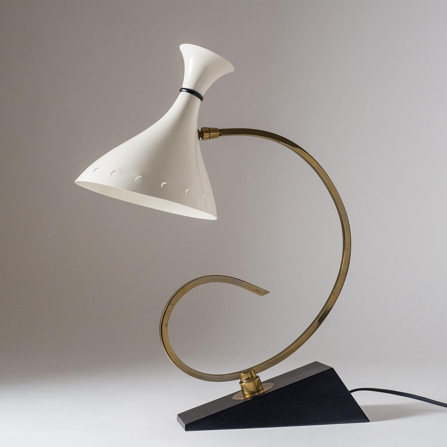 Very unique French midcentury table or desk lamp. An angular cast aluminum base, a uniquely sculpted brass stem, and a sensuous double-cone aluminum shade with rare moon shaped cut-outs. One brass and ceramic E27 socket with new wiring.