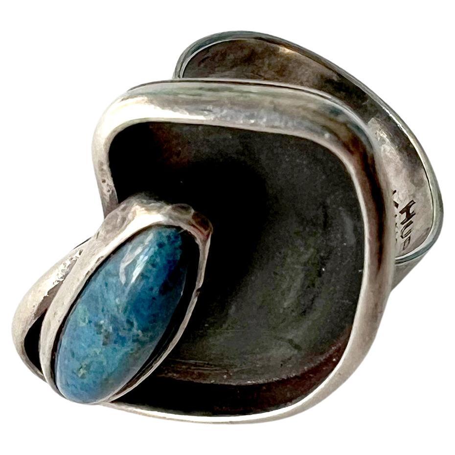 Rare, 1950s sterling silver ring with natural blue gemstone set within a palette shaped shadowbox and designed by Joan Hurst and Jill Kingsbury of New York City, New York. Ring is a finger size 6 and is signed Hurst Kingsbury, Sterling. Suitable for