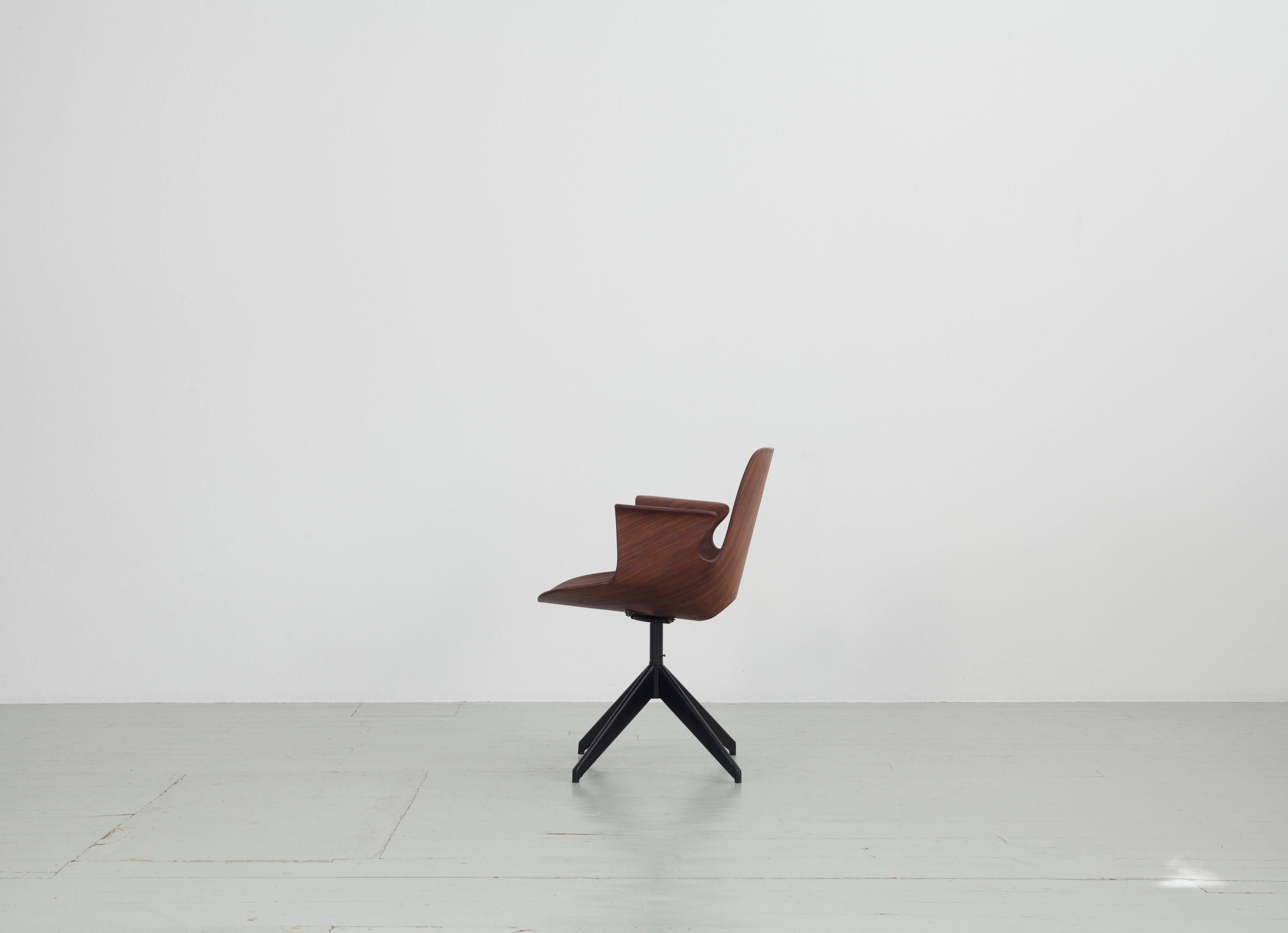 This 1950s swivel office chair “Medea” was designed by Vittorio Nobili and manufactured by Fratelli Tagliabue in Meda, Italy. The teak plywood seat swivels in all directions on a dark iron frame, making it an ideal office chair. In addition, it