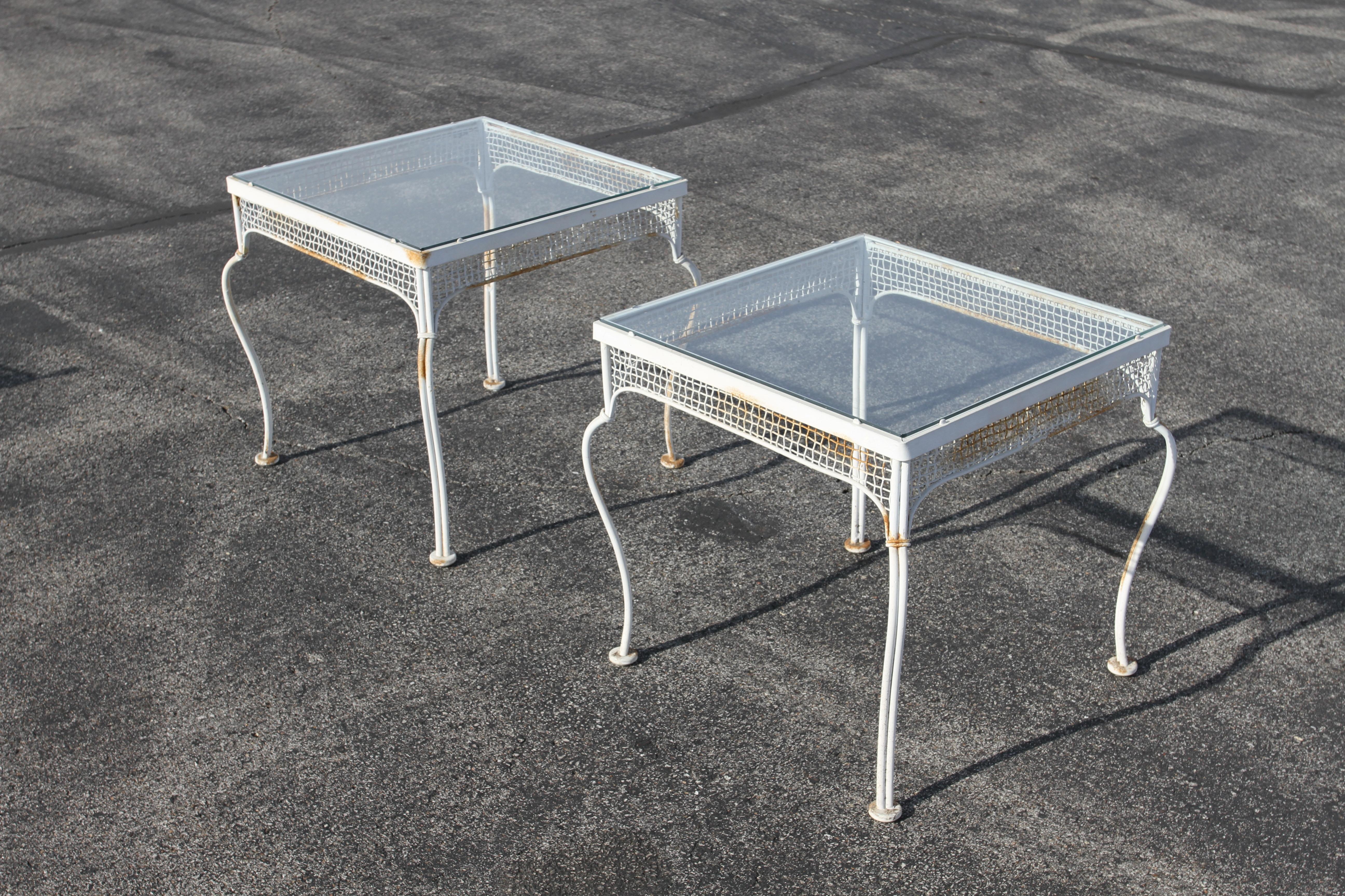 Classic and Rare 1950s midcentury Palm Beach style outdoor wrought iron and mesh patio / garden glass top end tables by Woodard Furniture Co. Part of a original set I'm offering for sale, see the matching tub / lounge chairs & table, round coffee