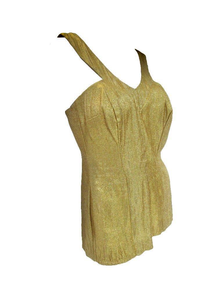   

Absolutely Amazing Treasure from Nettie Rosenstein

This late 40's / early 50's beauty features a glimmering gold lamé fabric that immediately catches the eye. Containing boning the seams follow the body to accentuate one's figure and the straps