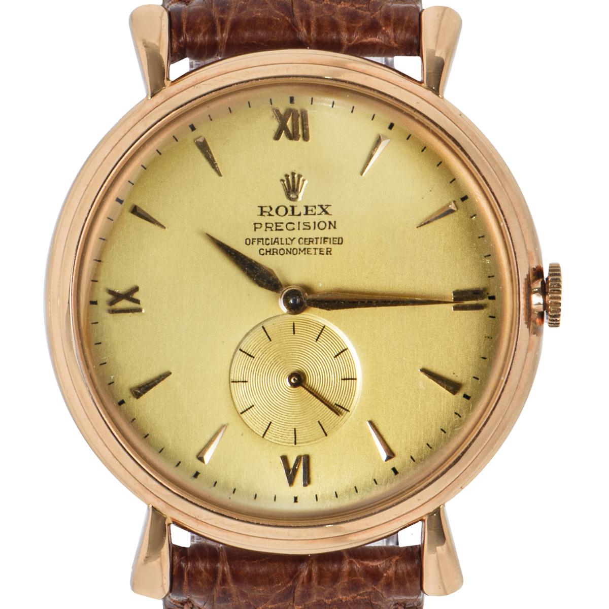 A 37mm 18k Rose Gold Vintage Precision Gents Wristwatch, a rare original chronometer champagne dial with applied 18k rose gold index batons and roman numerals at 3,6,9 and 12 0'clock, small seconds at 6 0'clock, a fixed 18k rose gold smooth bezel, a