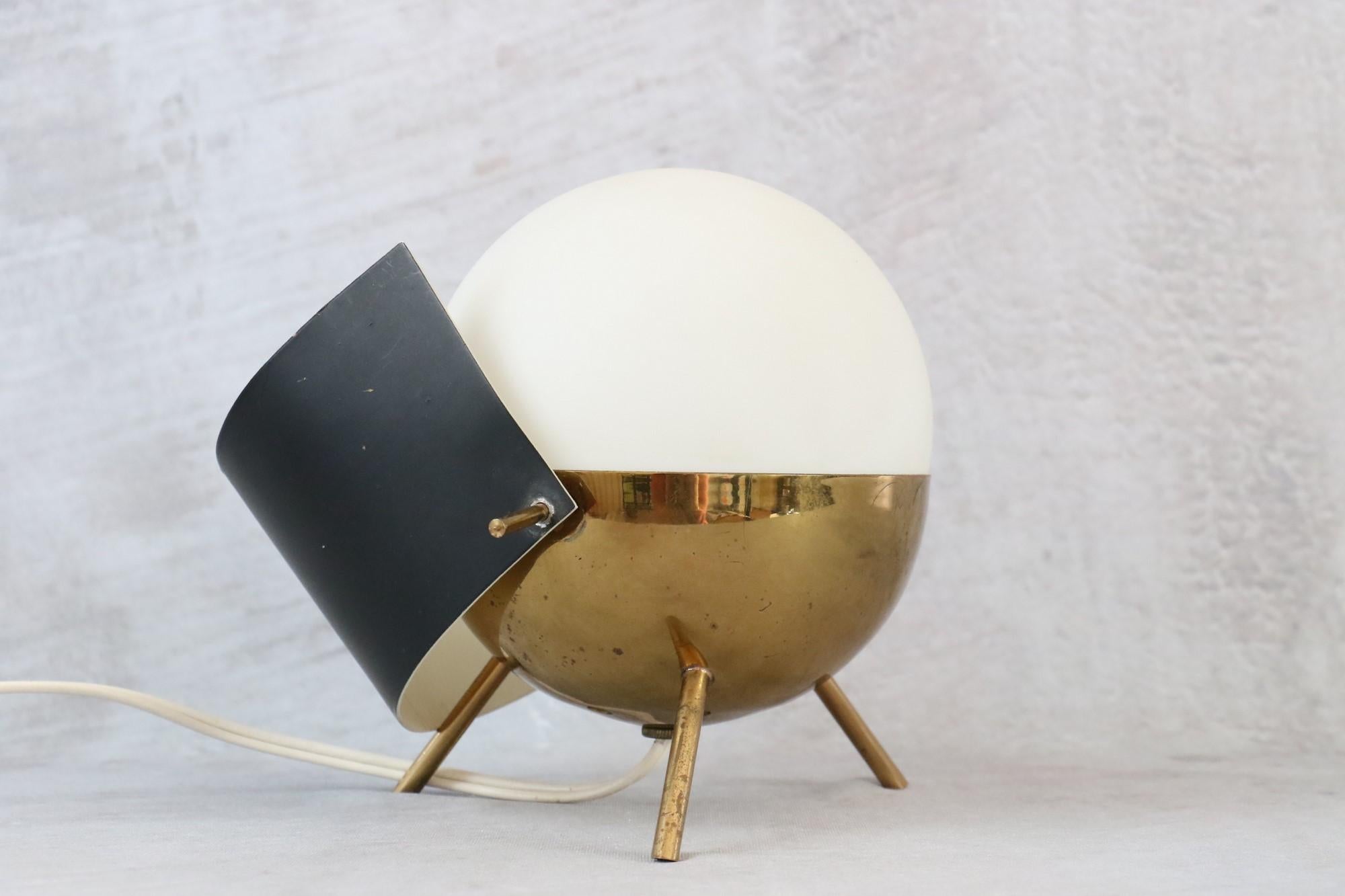 Rare 1950s Stilux Milano brass and opaline glass tripod table lamp

Stilux Milano tripod table lamp in gilded brass and opaline from the 1950s. 
It is characteristic of the highly refined aesthetic of mid-century Italian lighting design, embodied