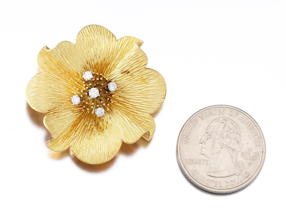 A gorgeous  Tiffany & Co. 18 karat gold and diamond floral blossom fur clip pin brooch and pendant for necklace. 

This lovely pin/pendant is fashioned as a blossoming dogwood flower with textured finish, set with 5 round brilliant cut diamonds,