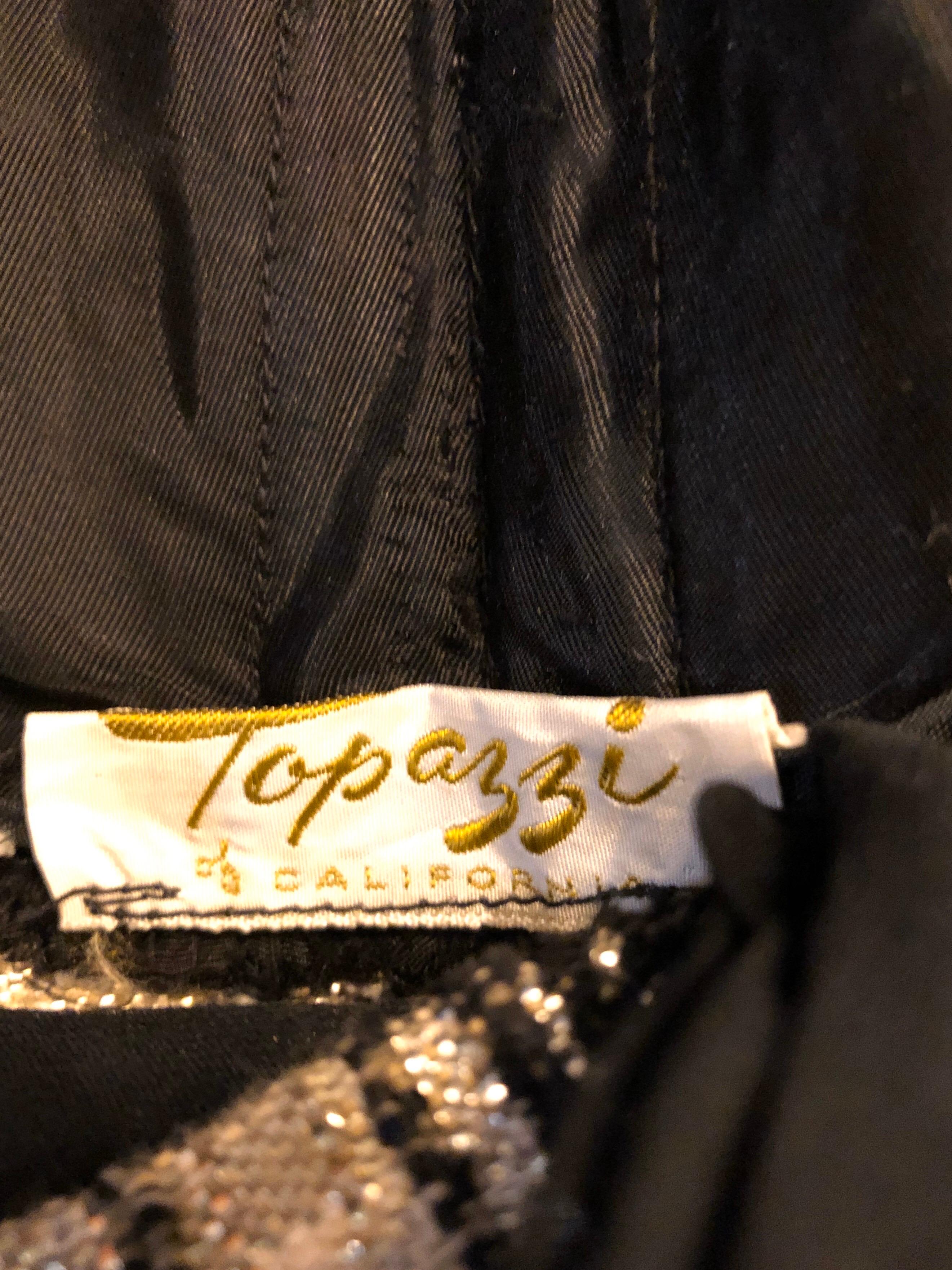 Rare mid 1950s TOPAZZI OF CALIFORNIA gold and black metallic one piece halter jumpsuit! Features flattering gold and black stripes throughout. Black silk chiffon straps criss cross in the back. Full metal zipper up the back with hook-and-eye