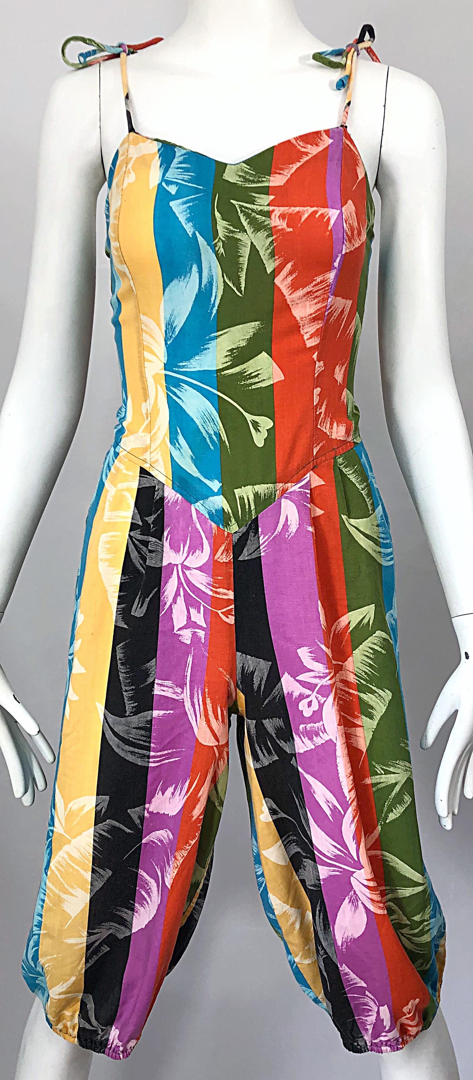 Rare 1950s tropical print lightweight cotton colorful one piece harem jumpsuit ( possibly Claire McCardell )! Features vibrant colors of purple, orange, blue, green, yellow, and black throughout. Ties at each shoulder strap to adjust length. POCKETS