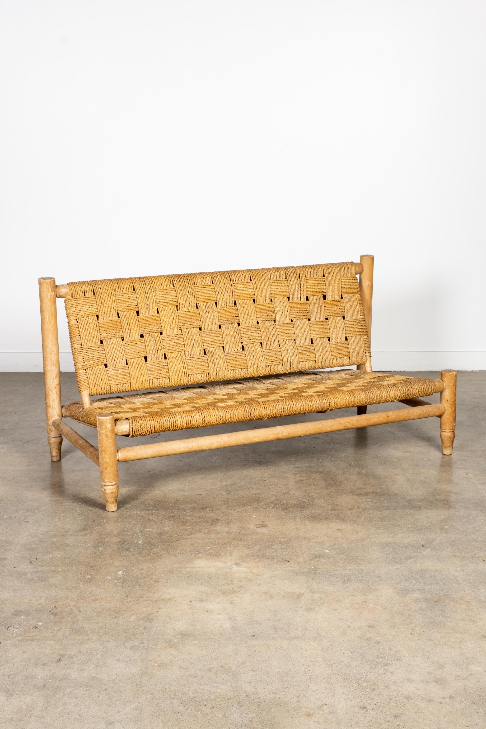 Beautiful 1950s 2-seater loveseat settee designed by French Modernist duo Adrian Audoux and Frida Minet. The primitive hand-turned beech frame clad in Original woven Abaca rope, references coastal living, while celebrating its humble materials - a