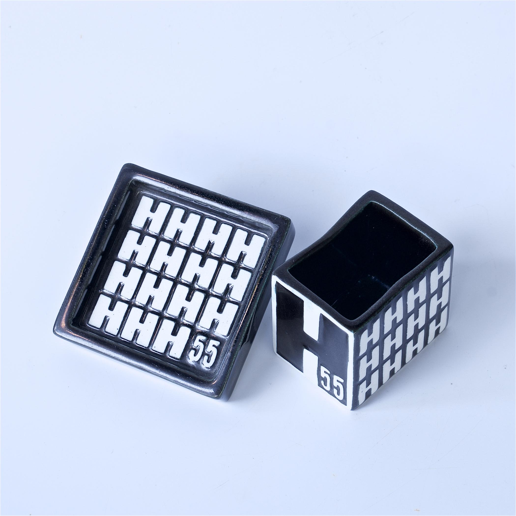 A rare two piece set, commemorating the Helsingborg Exhibition of 1955, and only produced for one year, for this exhibit.  No Gustavsberg collection is complete without something from the H55.

Cigarette Box W: 2.33 x D: 1.75 x H: 2 in.
Ashtray Dish