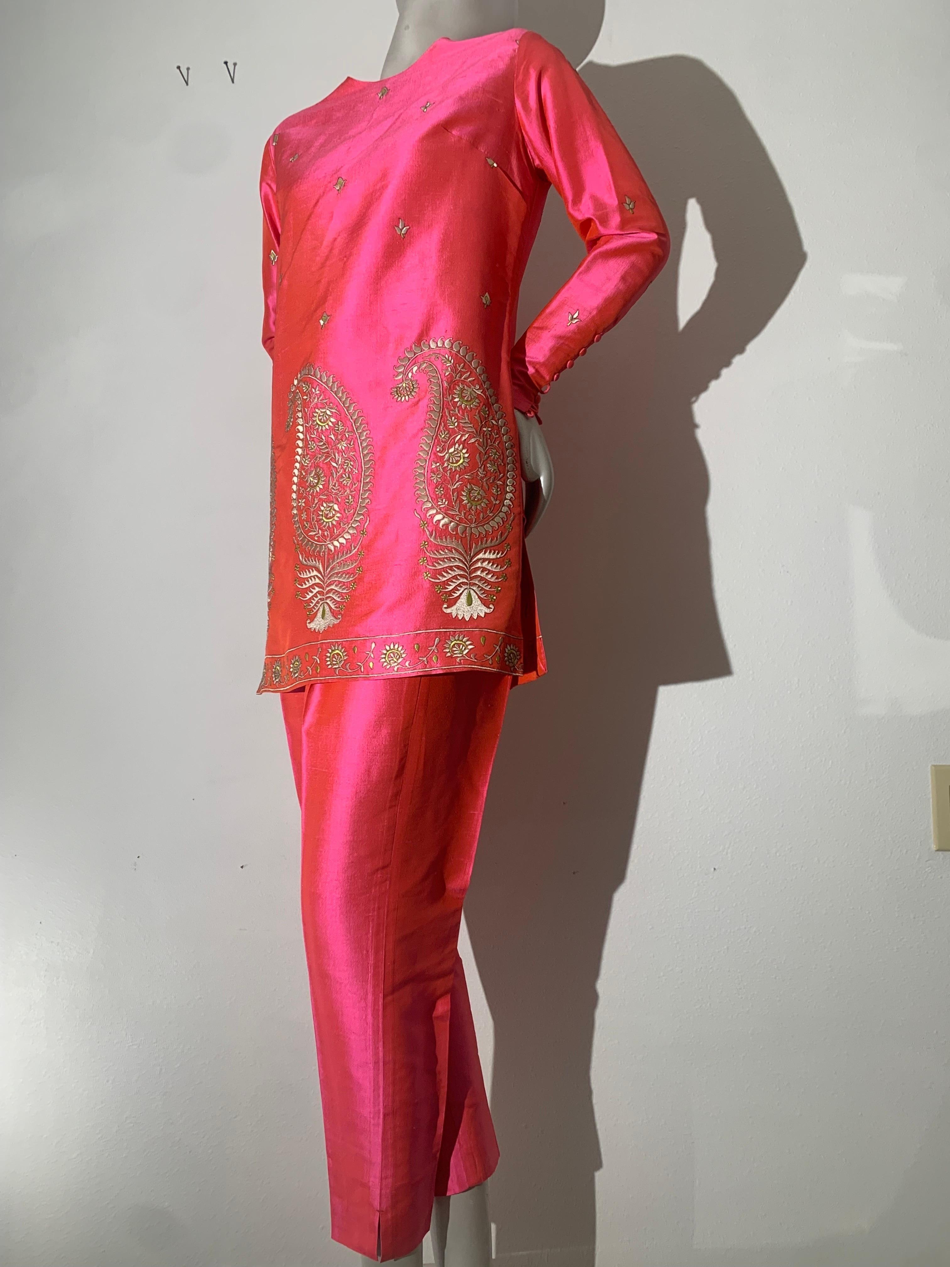 Rare 1957 Christian Dior Colifichets Florescent Pink Silk Two-Piece Pantsuit: This stunning ensemble is embroidered in silk floss in a traditional Indian paisley motif. Traditional tunic-style top with long tapered sleeves with covered buttons along