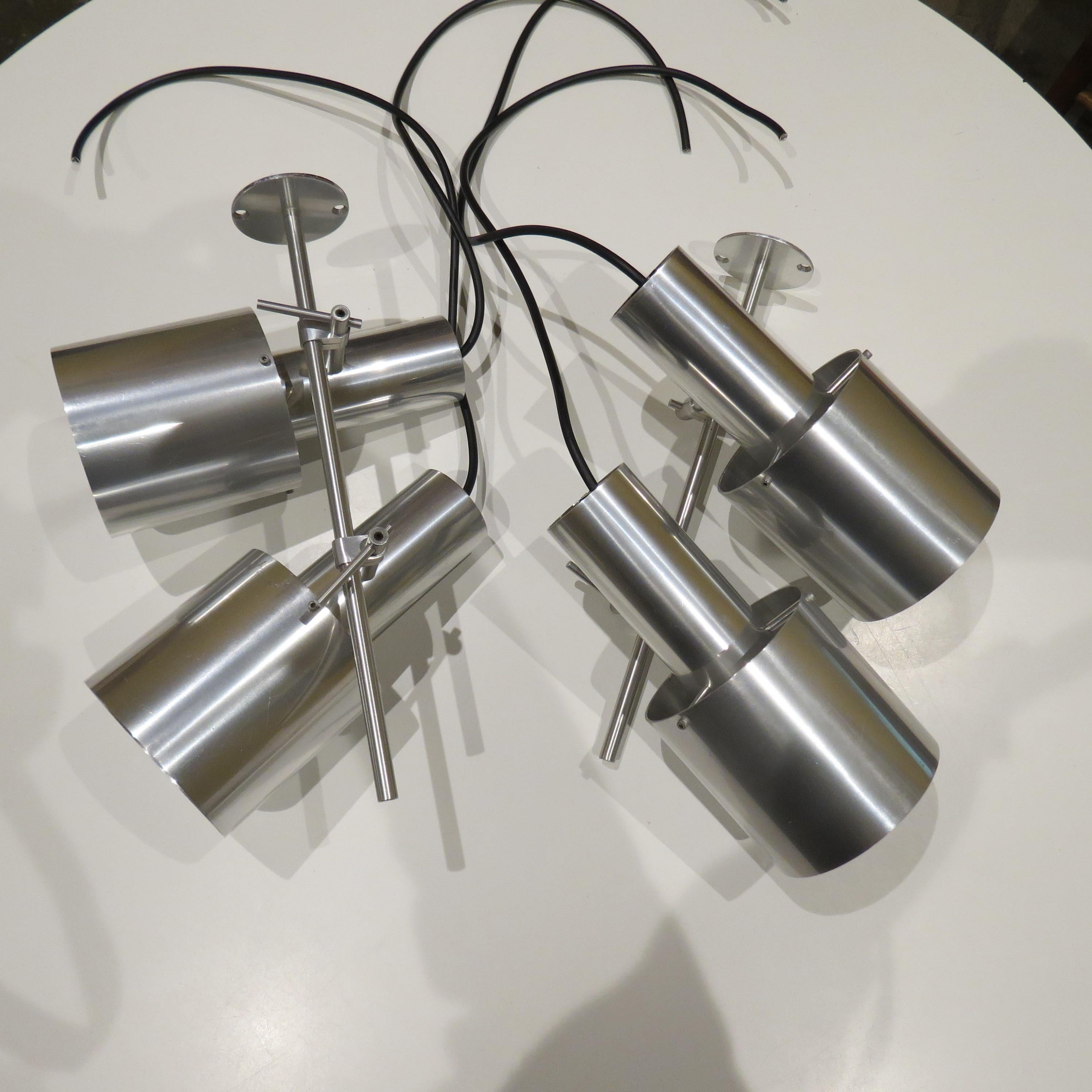 Rare aluminium ceiling light designed by Peter Nelson and produced by Architectural Lighting Ltd. Dates from the early 1960s.  The two spot lamps are adjustable, each lamp moves up and down the rod and also tilts to the required angle. Made from