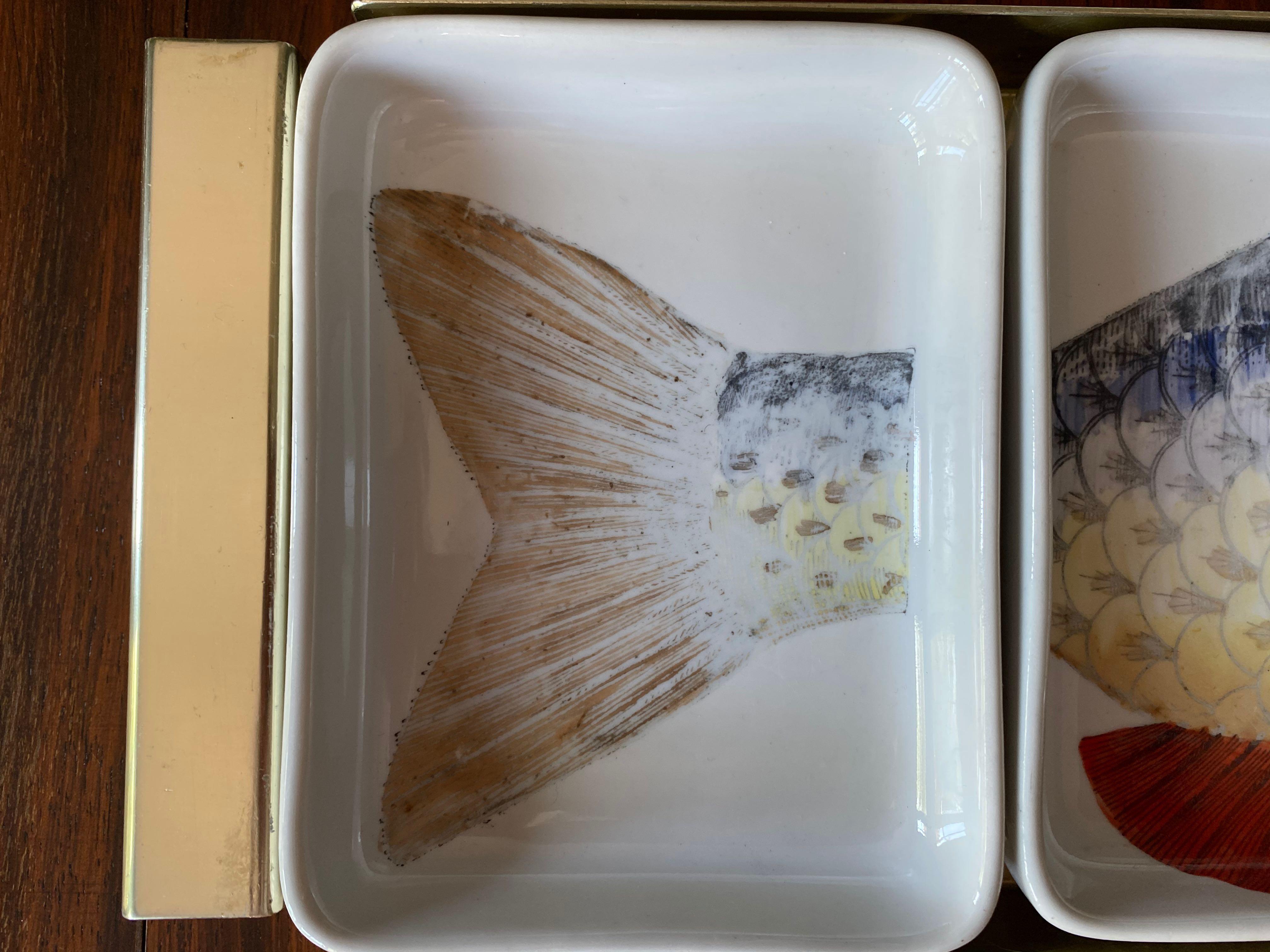 Appetizer tray consisting of four ceramic dishes

Gold metal tray

Printed section of fish on each dish

Fornasetti mark underneath

Slightly faded print

Reference: Fornasetti: The Complete Universe, Edited by Barnaba Fornasetti,