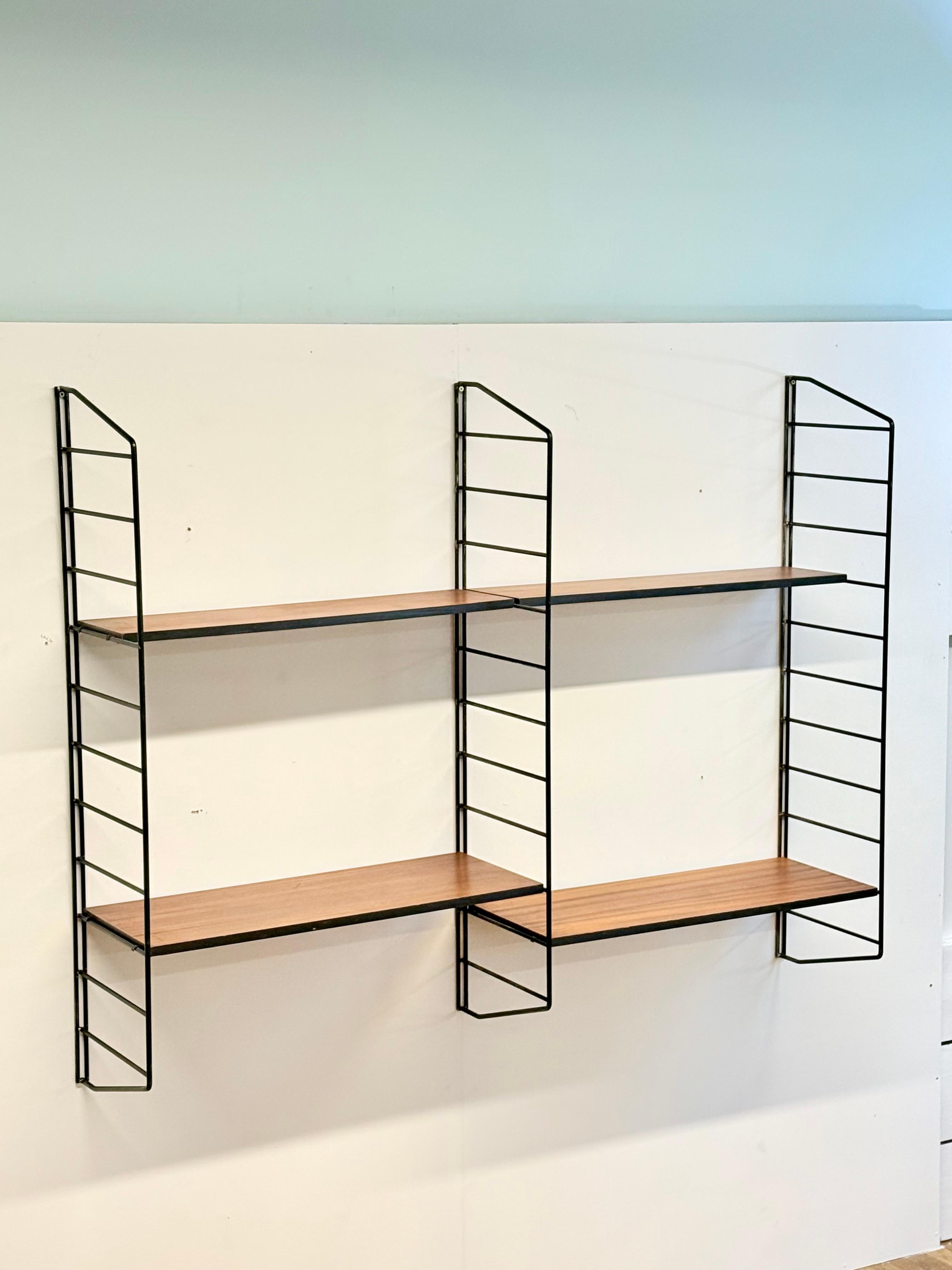 Mid-Century Modern Modular Teak and Metal Floating Shelving Wall Unit by Brianco, United Kingdom, 1960s

Elevate your interior with this exquisite mid-century modern floating shelving wall unit by Brianco, a British manufacturer based in Leeds, West