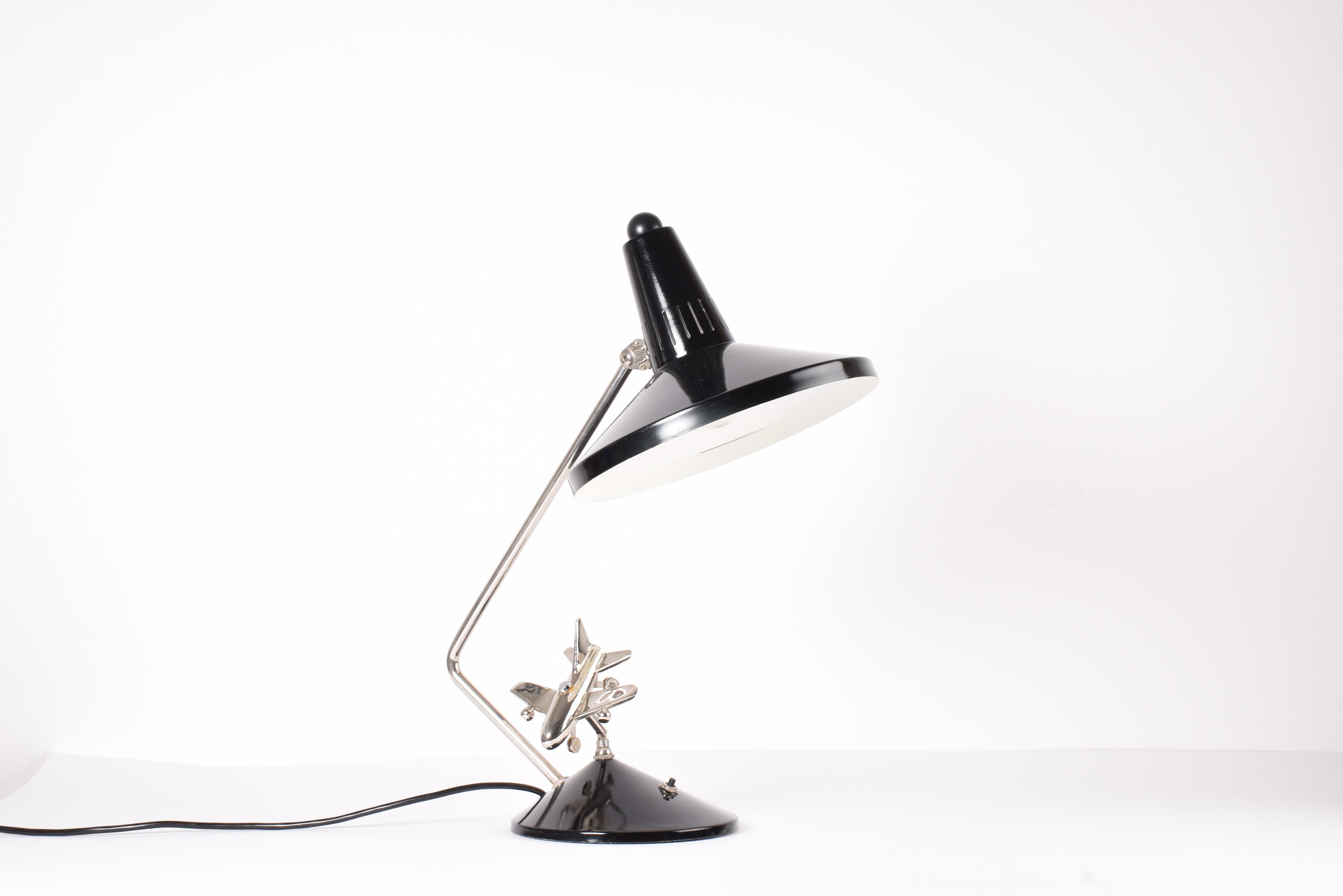 Rare desk lamp by Hala Zeist, Germany with special gimmick - a mobile airplane. Manufactured ca 1960s.
The shade and the arm can be moved in lots of directions.
The airplane can be turned in lots of directions - position for take off, landing and