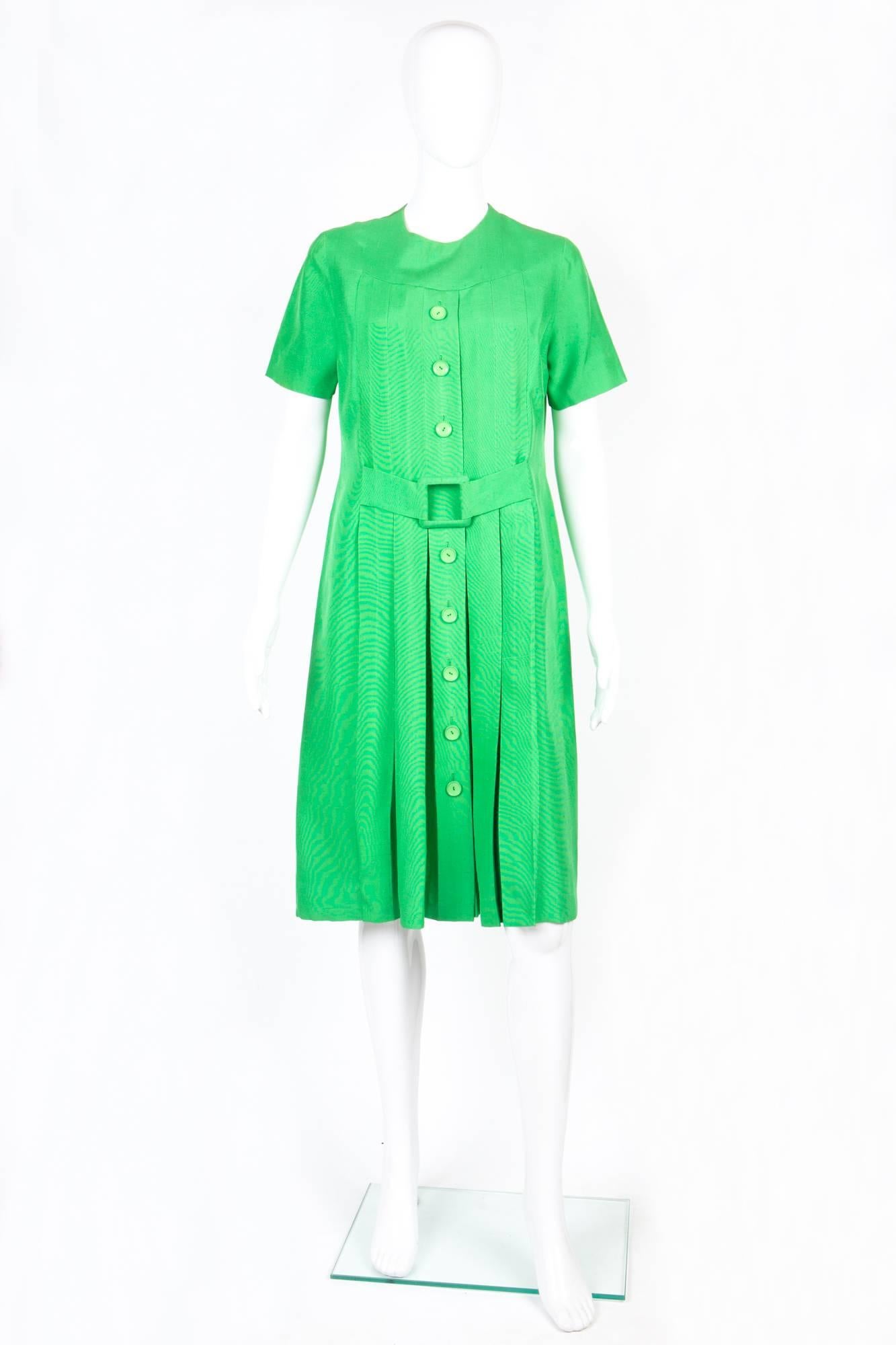 Rare 1960s Molyneux green silk handmade dress featuring  a center back zip opening, short sleeves, decorative front buttons & front decorative belt.
In good vintage condition. Made in France.
We guarantee you will receive this rare dress as