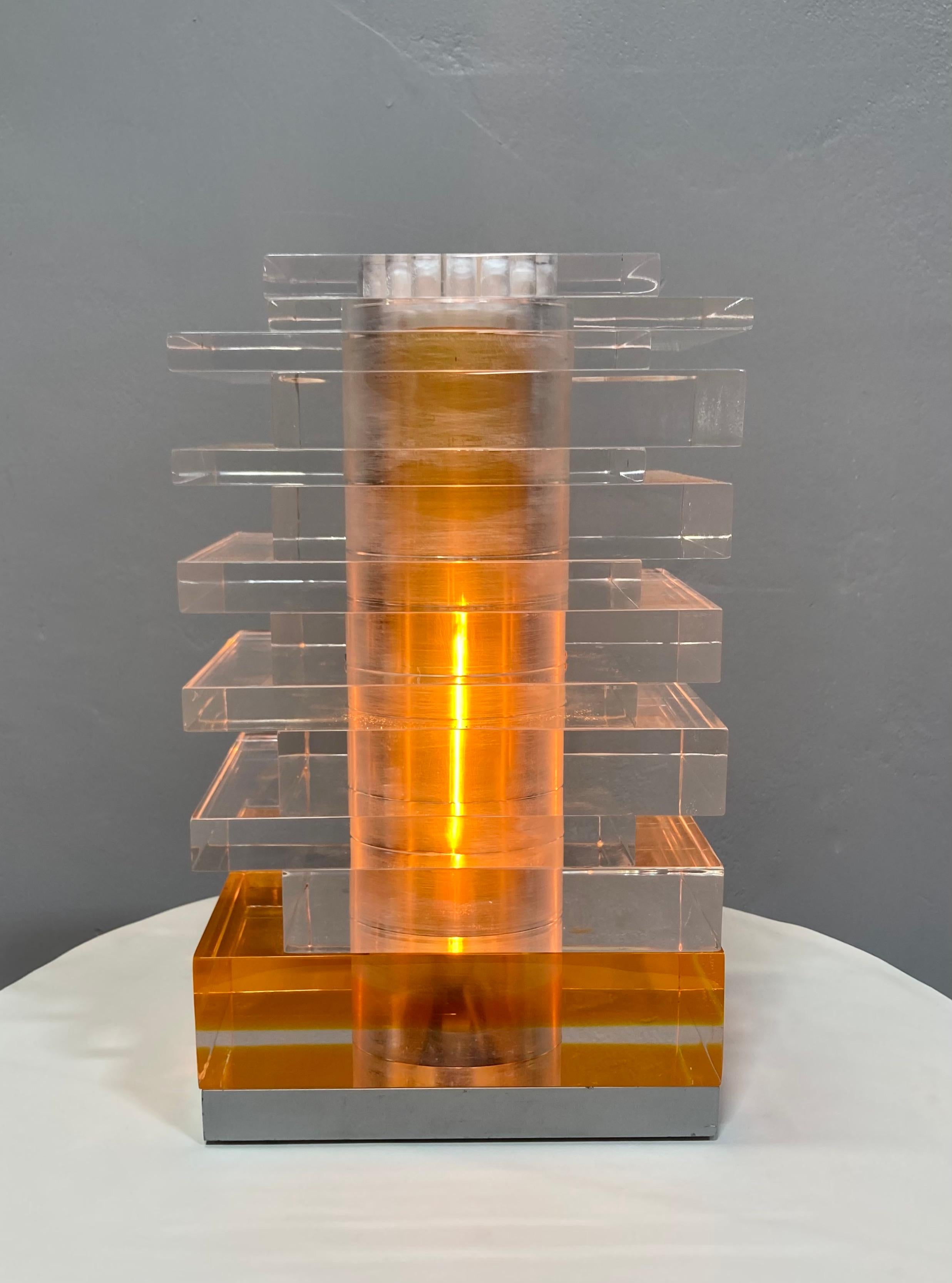 Presenting an incredibly rare mid-century find! Kinetic light sculpture lamp by Newlamp, and designed by Studio Uno in 1969. The plexiglass blocks pivot around the central structure, and effect the way light refracts through the blocks. Base segment
