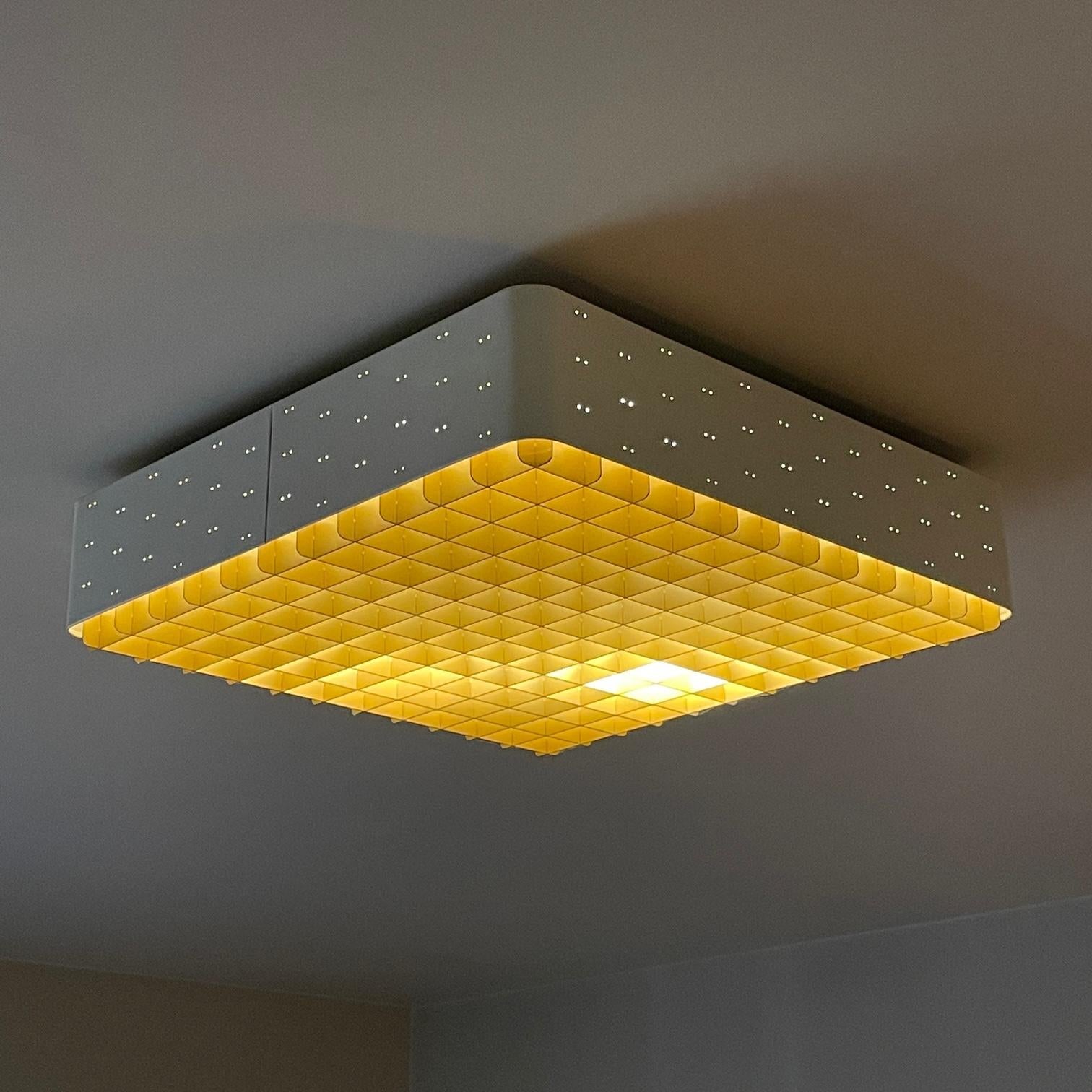Ready to be hardwired, with normal US 110v voltage. Houses 4 incandescent bulbs. 

This is a large 18x18 square “starry sky” ceiling lamp model #9068 by Paavo Tynell for Lightolier. Lacquered white perforated metal frame, anodized gold grid, and a