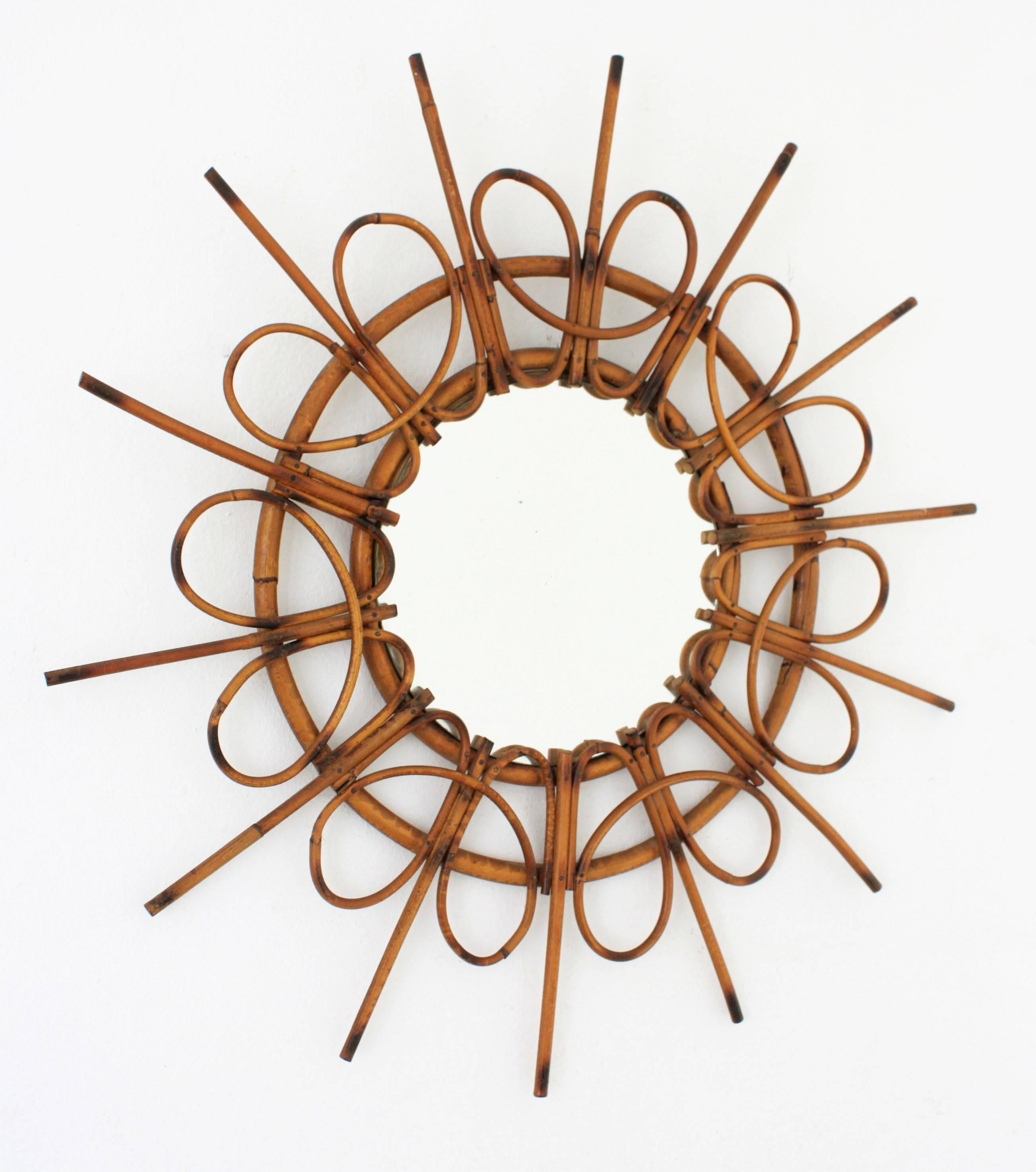 Unusual shape for this lovely rattan sunburst mirror with pyrography accents. First seen with these loops on the frame.
Beautiful to place alone. Spectacular creating a wall decoration with other cane mirrors from the period. Spain,