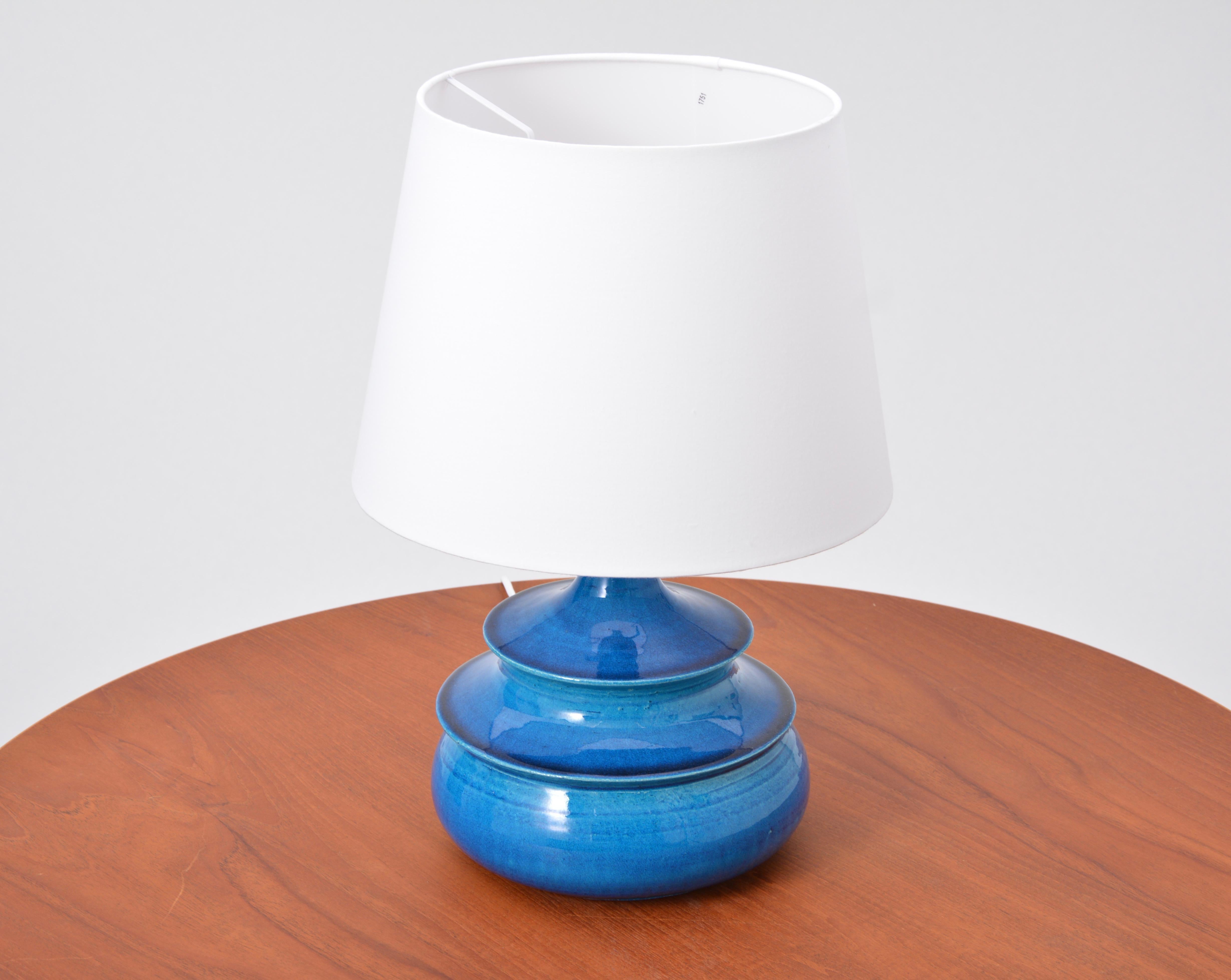 Turquoise Danish Mid-Century Modern table lamp by Nils Kähler

This circular table lamp was designed by Nils Kähler in the 1960s in Denmark and produced by the company HA Kähler. It is made from glazed ceramic in a beautiful turquoise. Excellent