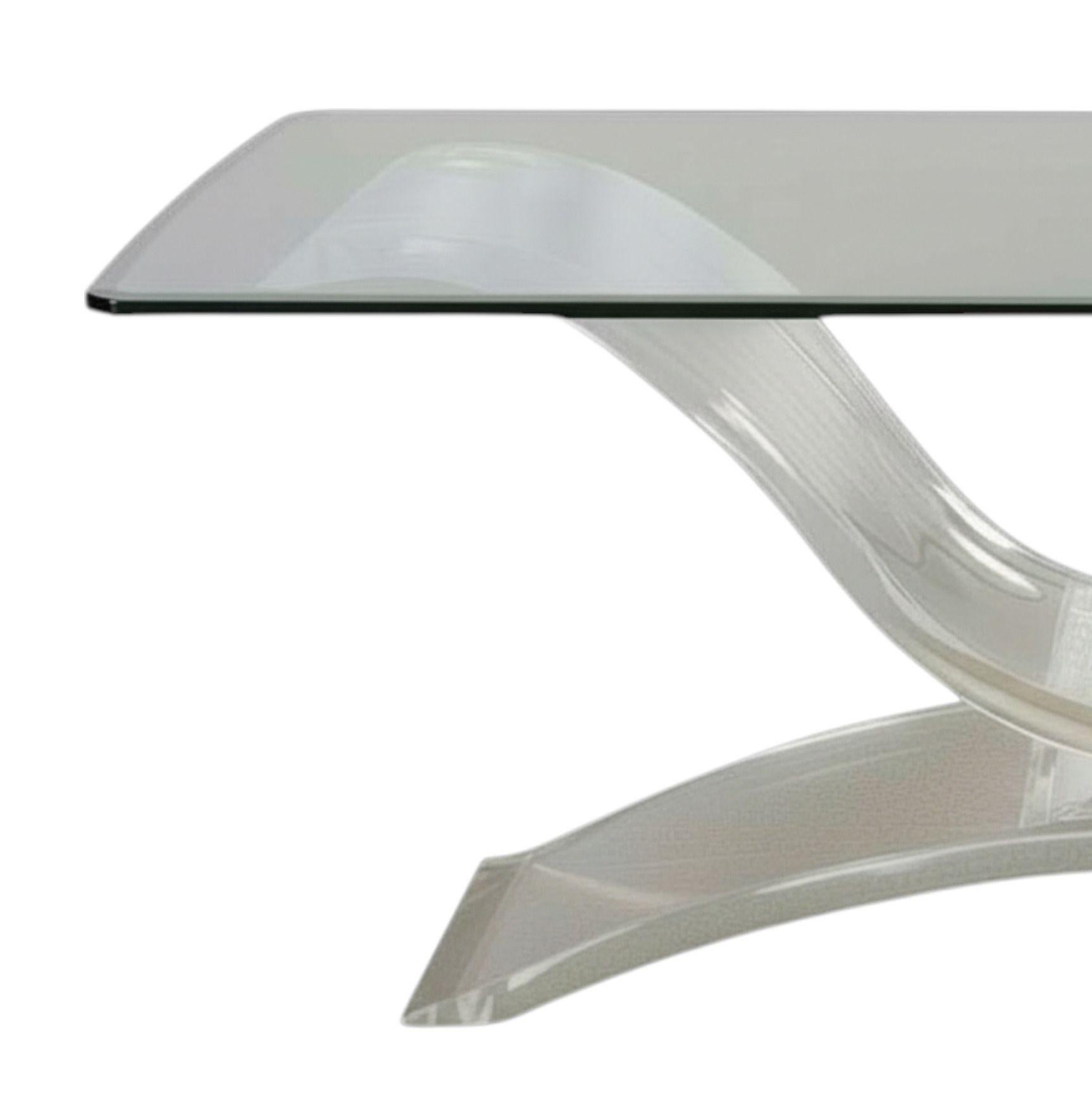 Stunning and Rare Mid-Century American Art Deco Style Lucite & Glass Console Table. Made in the USA, circa 1970's.
This piece embodies the glamorous use of materials and sculptural form. The design is defined by its substantial, architectural Lucite