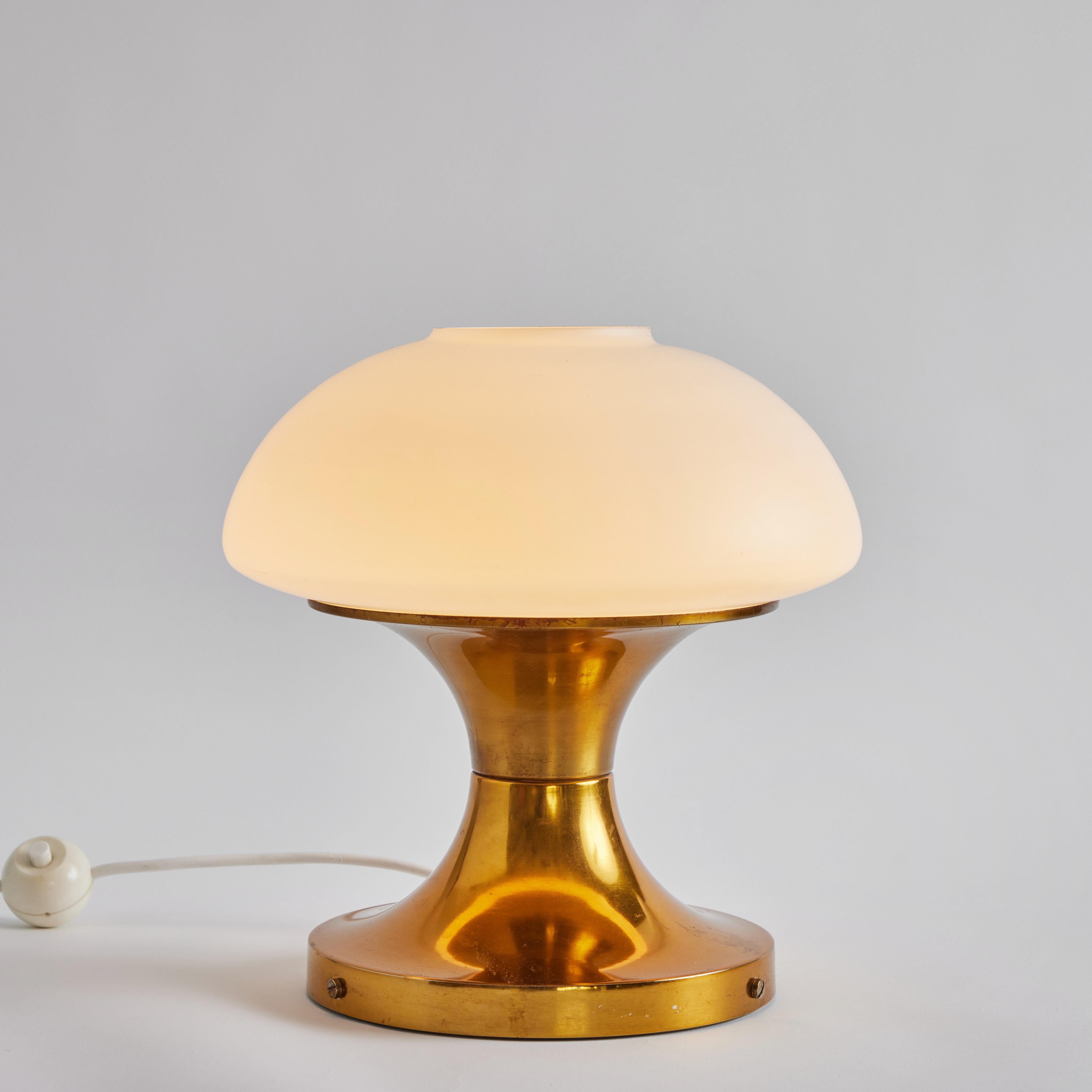 Rare 1970s brass & glass table lamp for AKA Elektrik, East Germany. This extremely rare and iconic design is executed in brass and opaline glass with original sculptural on/off switch. Retains original manufacturer's stamp.

AKA Elektrik / VEB