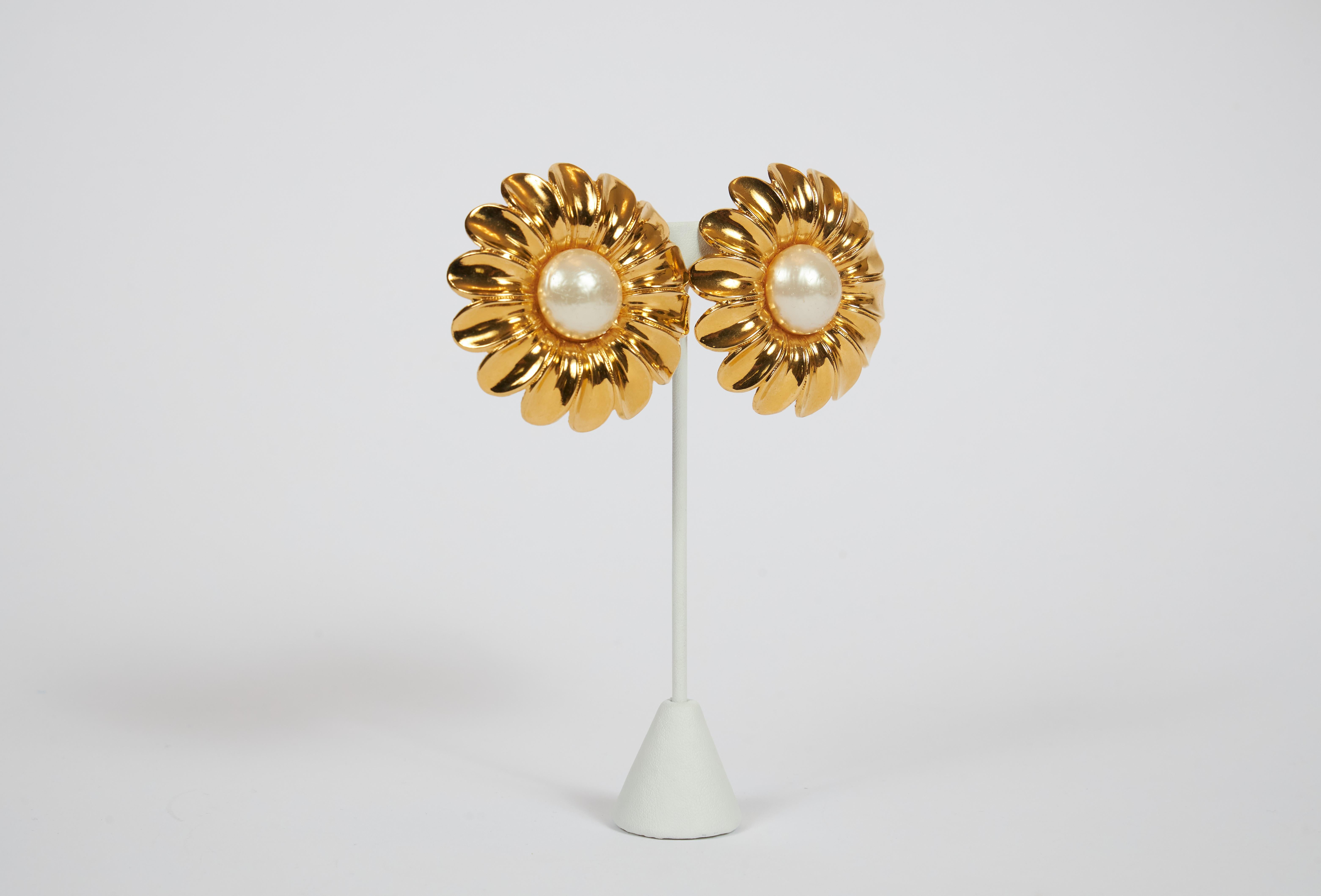 Chanel oversized and collectible daisy clip earrings with center faux made pearl. Come with original box.