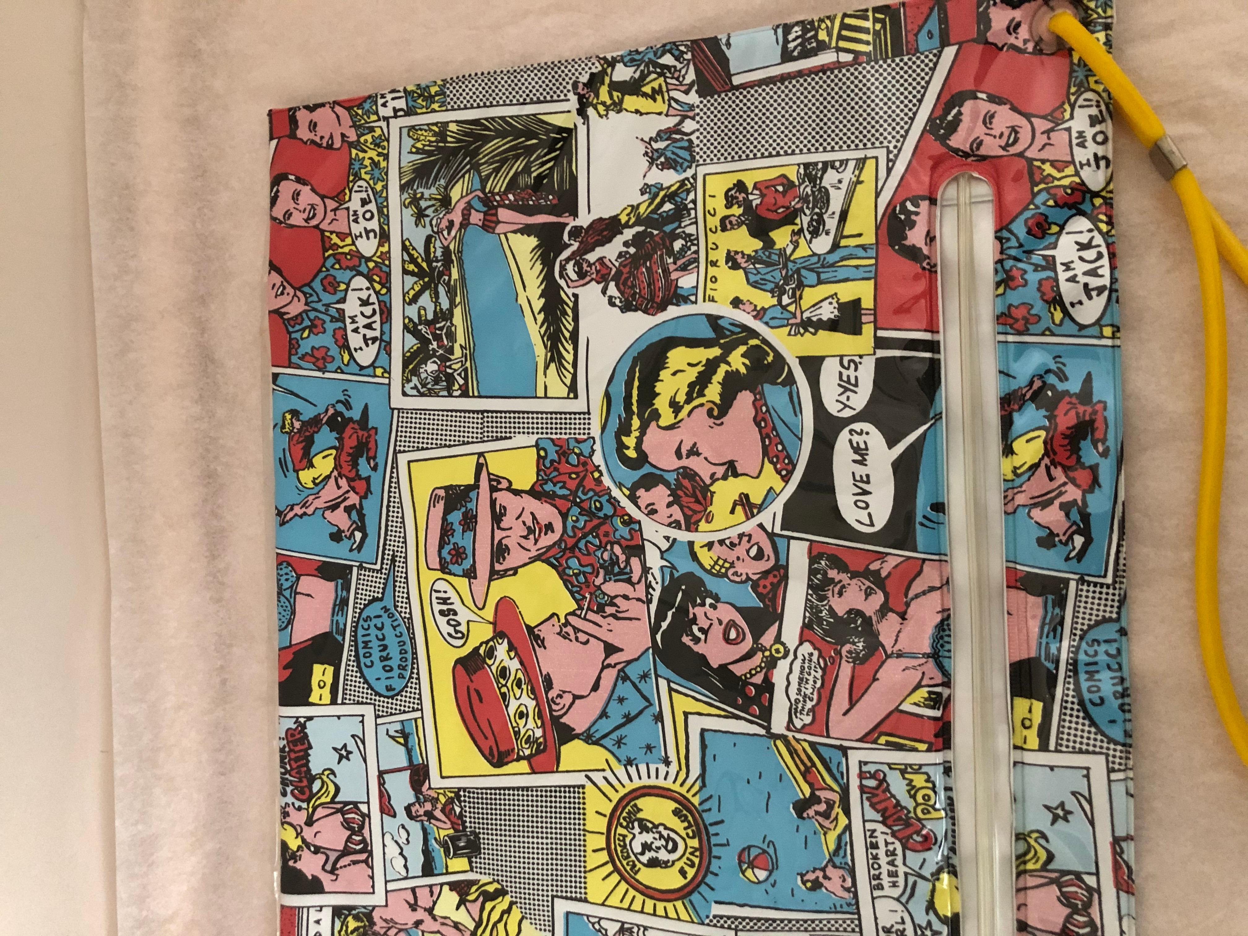 This is a unique piece and most everybody knows of the Archie Comics. This is not only a clutch but iconic images with a pop art look. There is a top zip closure, as well as a zip pocket at the front.
The colors are bright and fresh, and this clutch