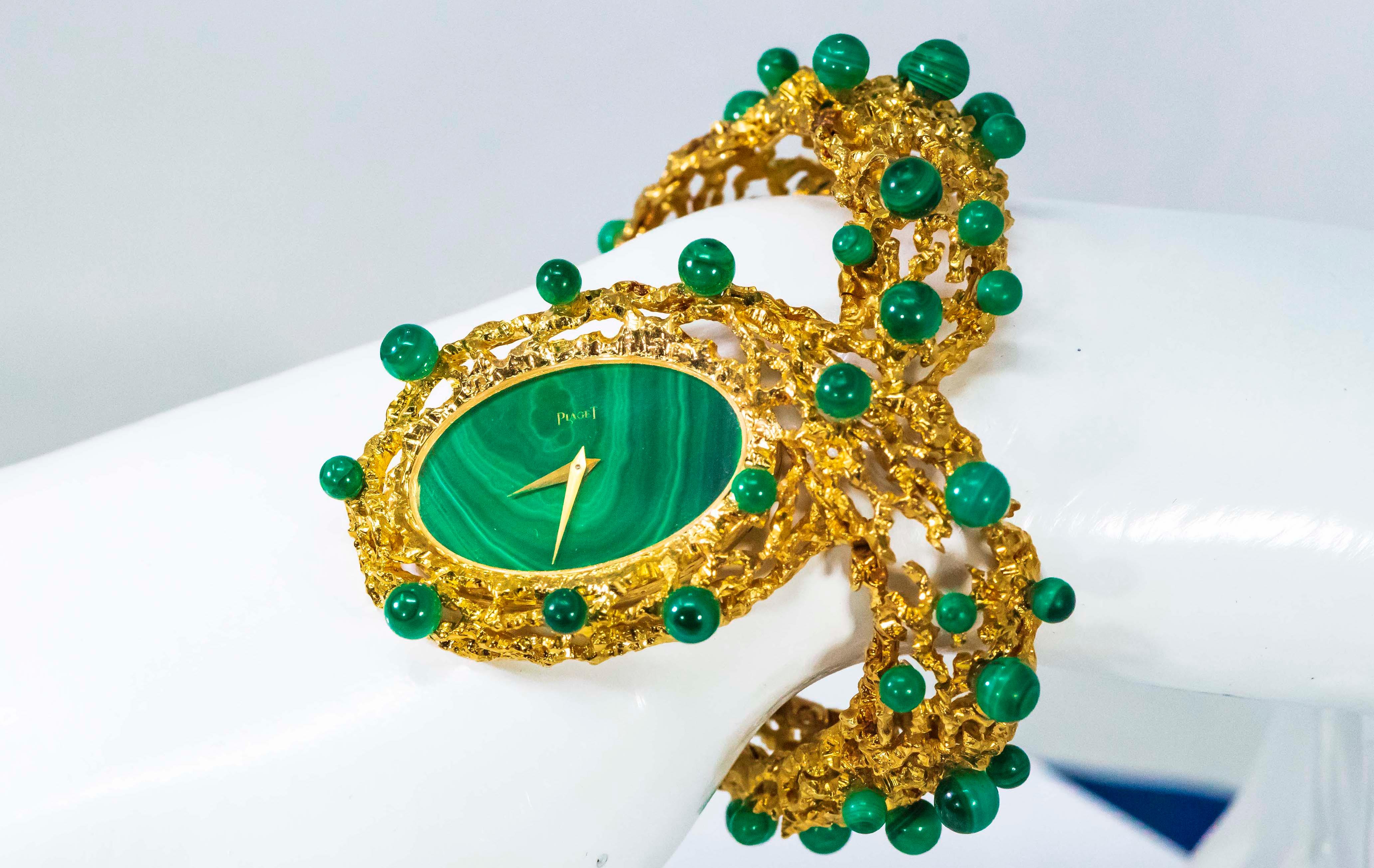 An Extremely Rare & Impressive Vintage 1970s Piaget w/ 18kt Yellow gold Textured Openwork bangle Design & highly sought after Malachite Dial and Malachite Rondel Motif Pattern Running Along the Bangle Cuff Bracelet


Timepiece Dimensions:

- 32mm X