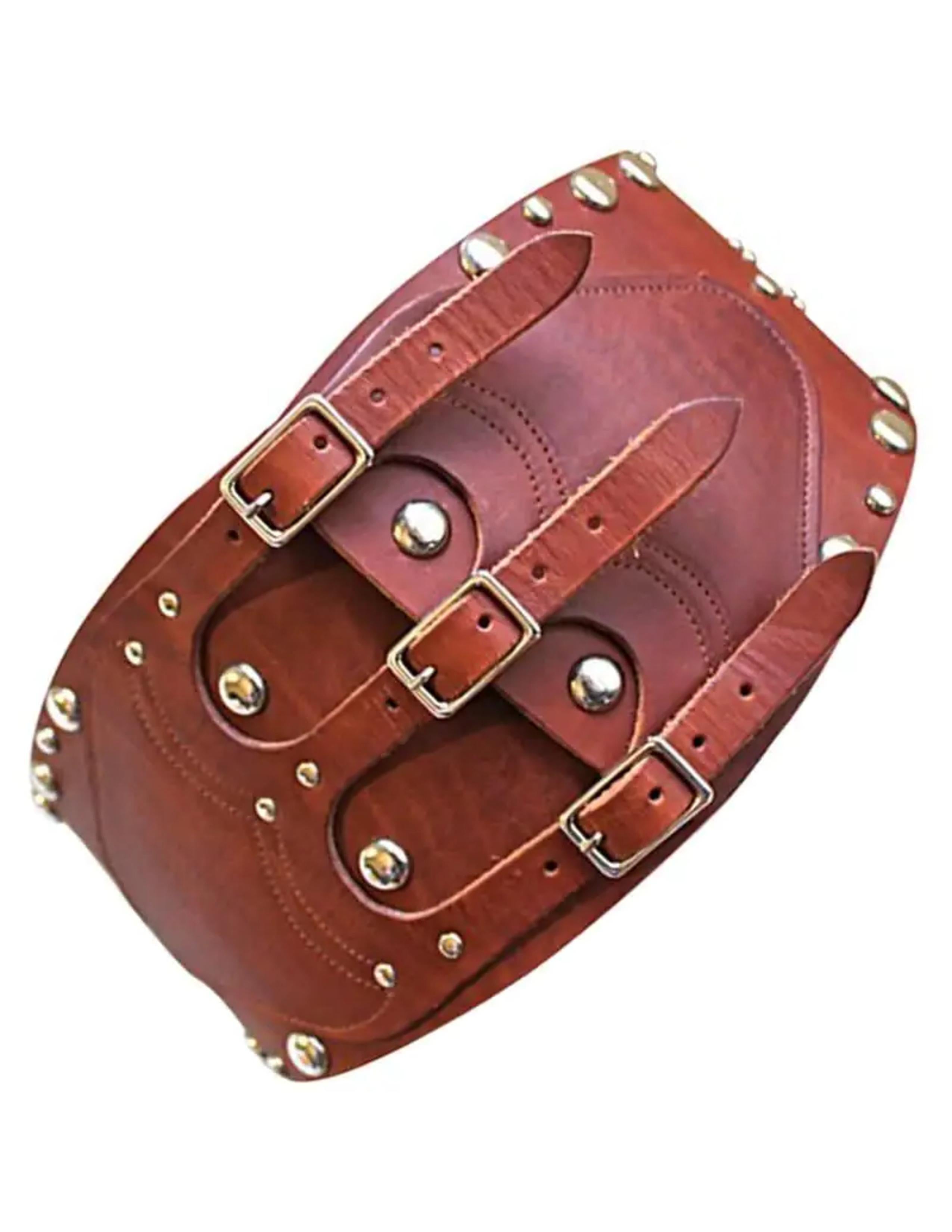 Very rare brown leather corset belt with silver studs from Ralph Lauren dating to the 1970's. Two red faceted glass stone accents at back. Gorgeous rich brown patina. Very thick leather. No size indicated, however belt comfortably fits a 28-31